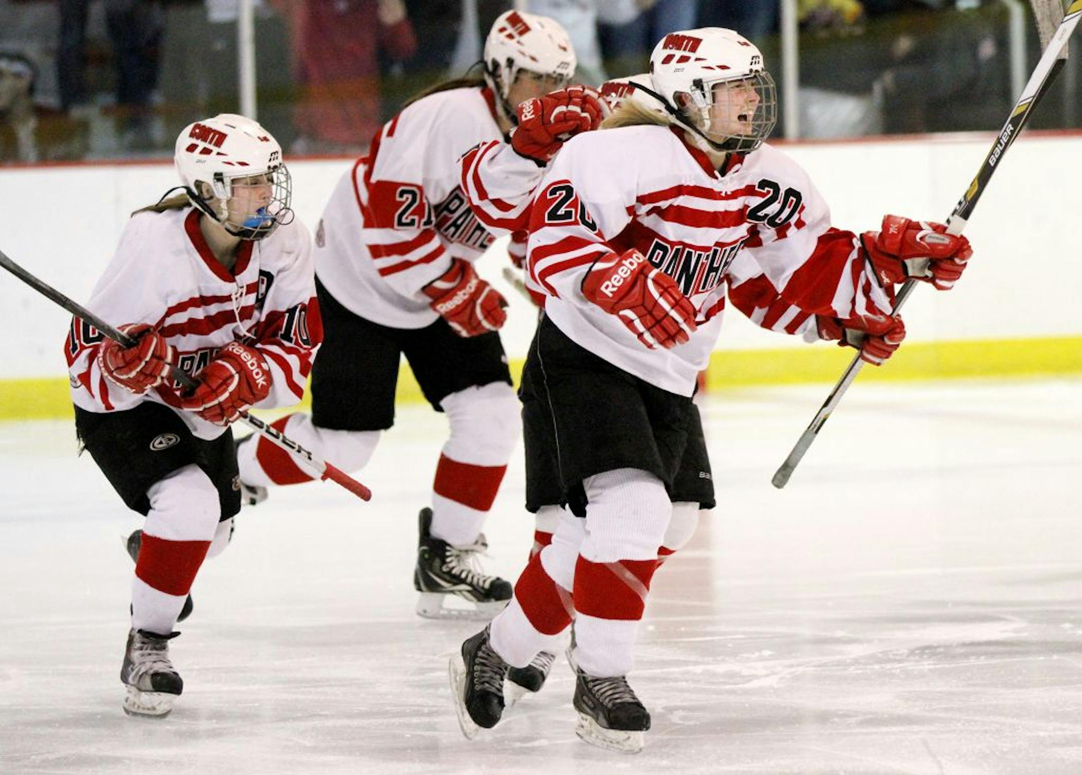 Lakeville North's Alexis Joyce, no. 20, right, celebrated with teammates after making the second goal of the night against Eden Prairie.