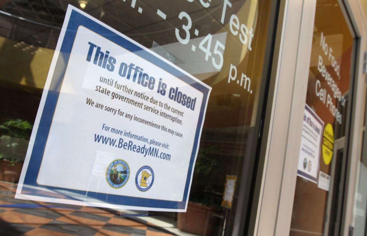 A sign posted on the doors of the downtown St. Paul Minnesota Driver and Vehicle Services office, let people know it was closed because of the state government shutdown in July.