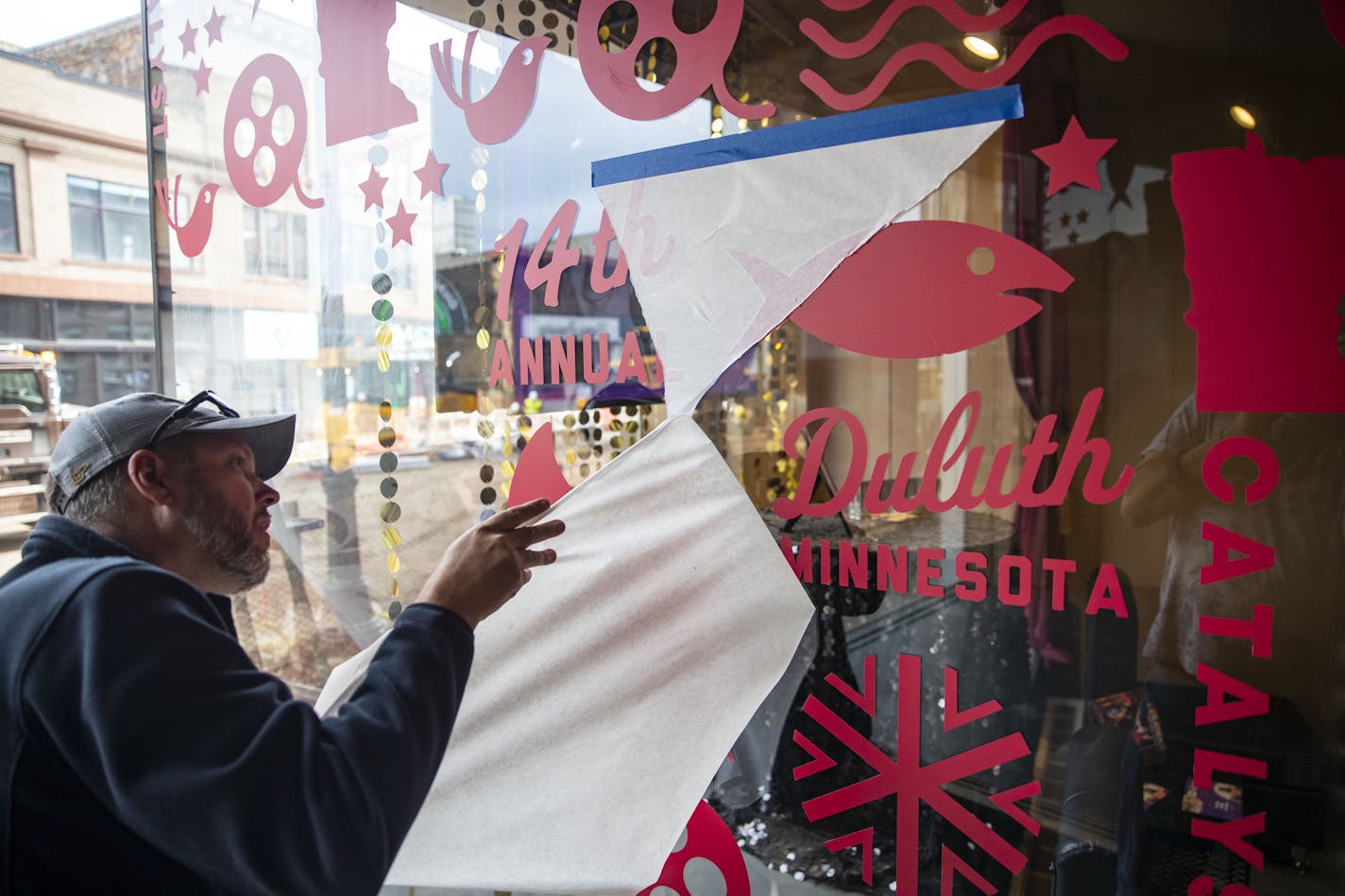 Craig Vanneste, a vinyl installer from Advantage Emblem and Screen Printing, worked on placing advertisements for the Catalyst Film Festival on the outside of the NorShor Theater in downtown Duluth on Tuesday. ]
ALEX KORMANN &#x2022; alex.kormann@startribune.com The Catalyst Film Festival will be coming to Duluth, MN on October 9th and run through the 13th. It will be hosted at the NorShore theater and Zeitgeist.