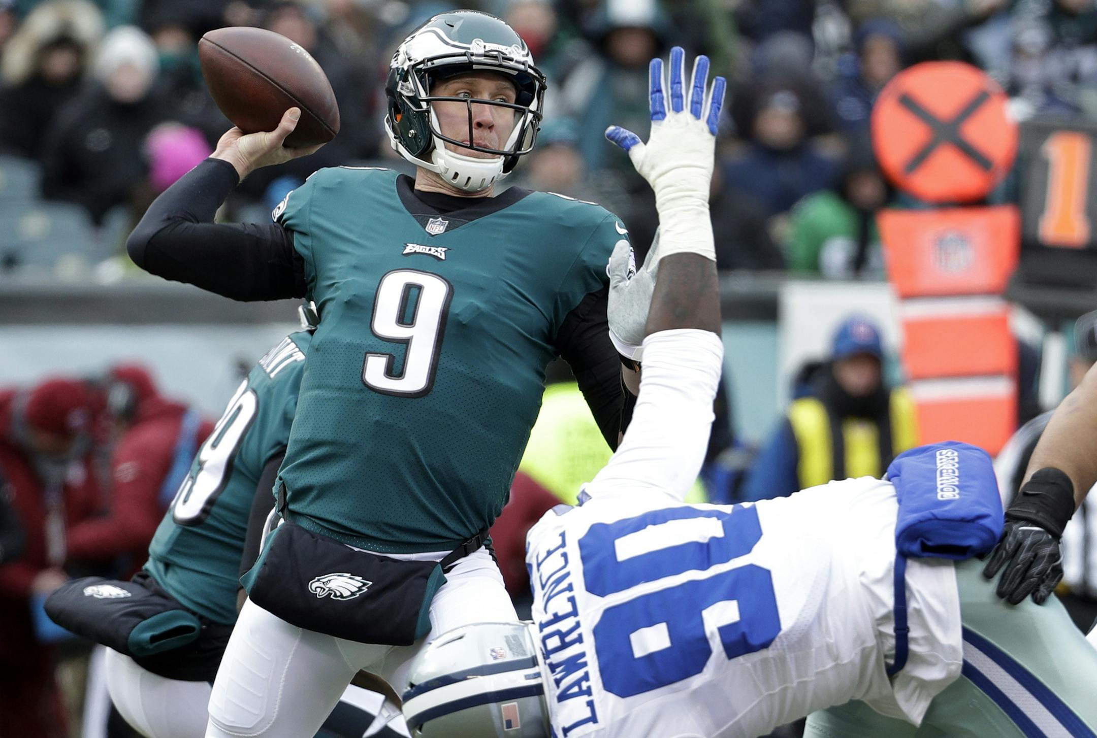 FILE - In this Dec. 31, 2017, file photo, Philadelphia Eagles' Nick Foles (9) throws a pass over Dallas Cowboys' DeMarcus Lawrence (90) during the first half of an NFL football game in Philadelphia. The Eagles earned the top seed in the NFC playoffs for the first time since 2004. (AP Photo/Chris Szagola, File) ORG XMIT: NY173