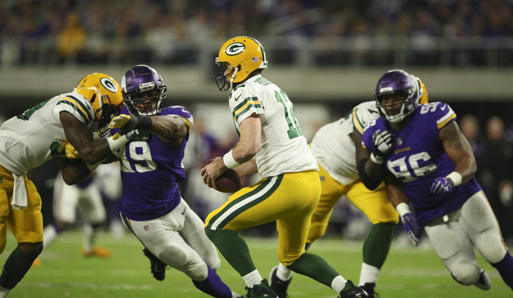 Vikings defensive end Danielle Hunter (99) and defensive tackle Tom Johnson (96) pursued Packers quarterback Aaron Rodgers (12) before he was sacked by Vikings defensive tackle Sheldon Richardson (93) for a nine yard loss in the third quarter.