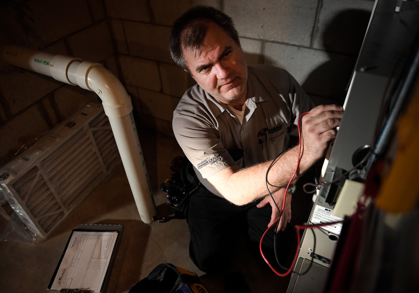 Michael Engel, with Marsh Heating and Air Conditioning, used a multimeter during a tune-up of a heater Thursday afternoon. Thursday afternoon. ] AARON LAVINSKY &#xef; aaron.lavinsky@startribune.com It's furnace tune-up season, but the $59 tuneup can sometimes become a red tag special. Unscrupulous HVAC contractors sometimes lowball the tuneup and then shut it down (red tagging it) because of a cracked heat exchanger. Smart consumers get a second opinion. We photograph Michael Engel as he inspect