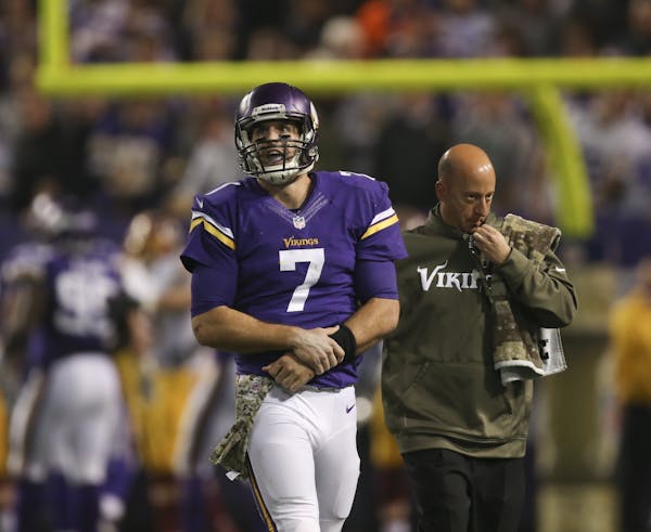 Vikings quarterback Christian Ponder was attended to by a trainer after injuring his left shoulder on Thursday night against Washington.
