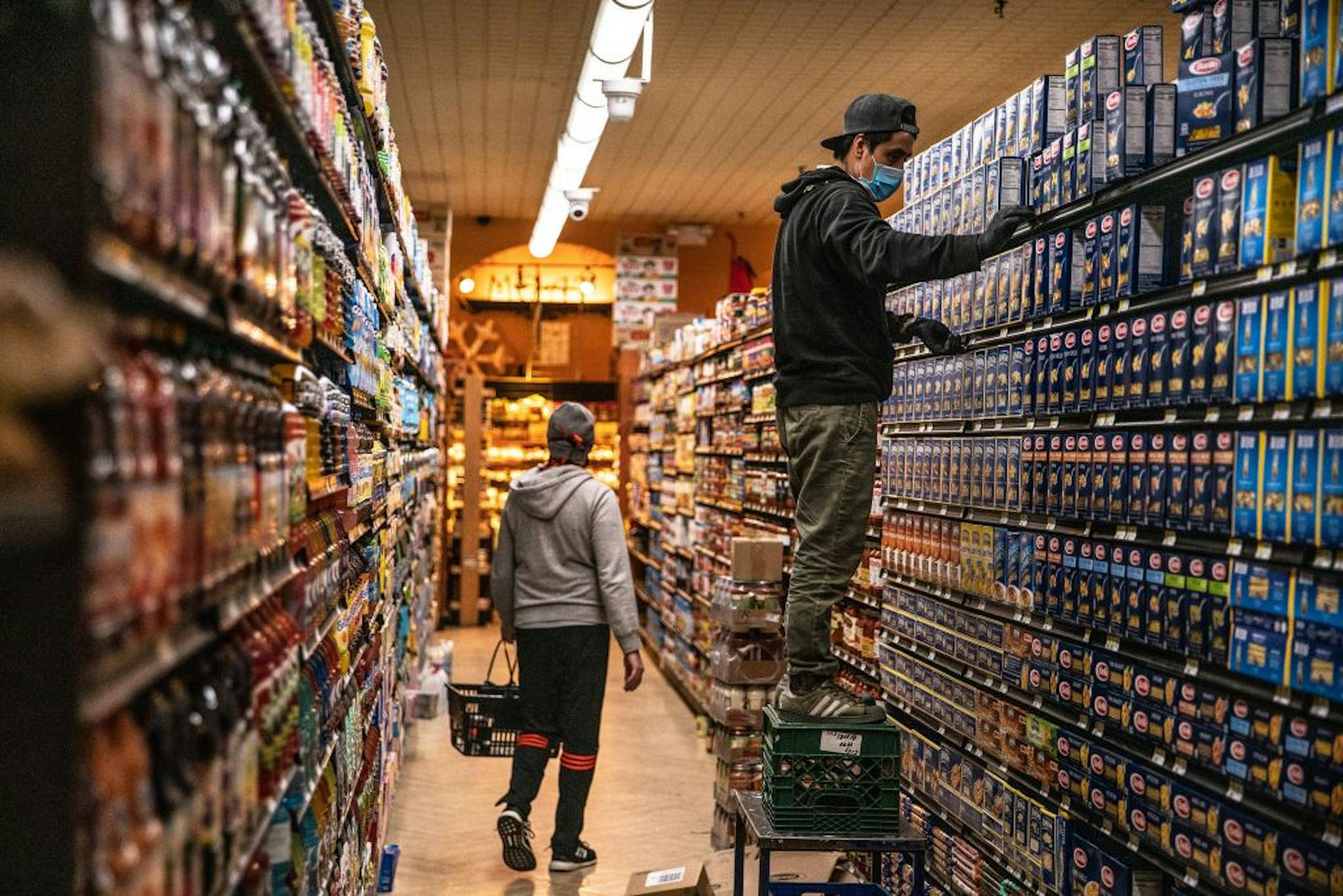 FILE -- A worker stocks shelves in a Brooklyn grocery store on April 16, 2020. Shoppers are accustomed to enjoying an extraordinary variety of choices, but the coronavirus pandemic has changed that.
