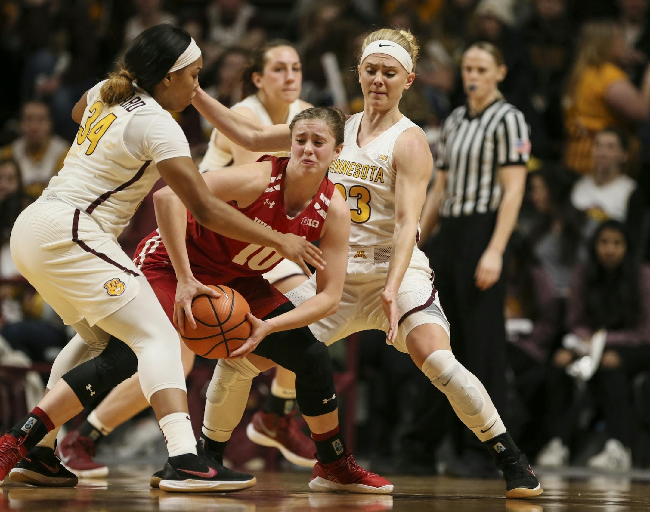 Minnesota Golden Gophers guard Gadiva Hubbard (34) and Minnesota Golden Gophers guard Carlie Wagner (33) trapped Wisconsin Badgers guard Kendra Van Leeuwen (10) as she tried to pass in the second half.