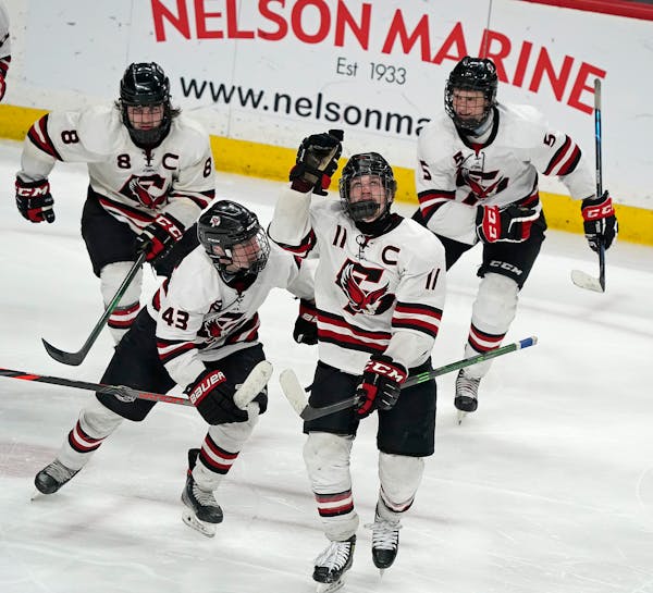 Eden Prairie forward Carter Batchelder (11) celebrated a goal during the third period. He later scored the game-winner in overtime.