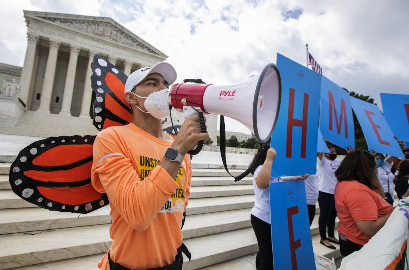 Deferred Action for Childhood Arrivals (DACA) recipient Roberto Martinez, left, celebrates in front of the Supreme Court after the Supreme Court rejected President Donald Trump's effort to end legal protections for young immigrants, Thursday, June 18, 2020, in Washington.