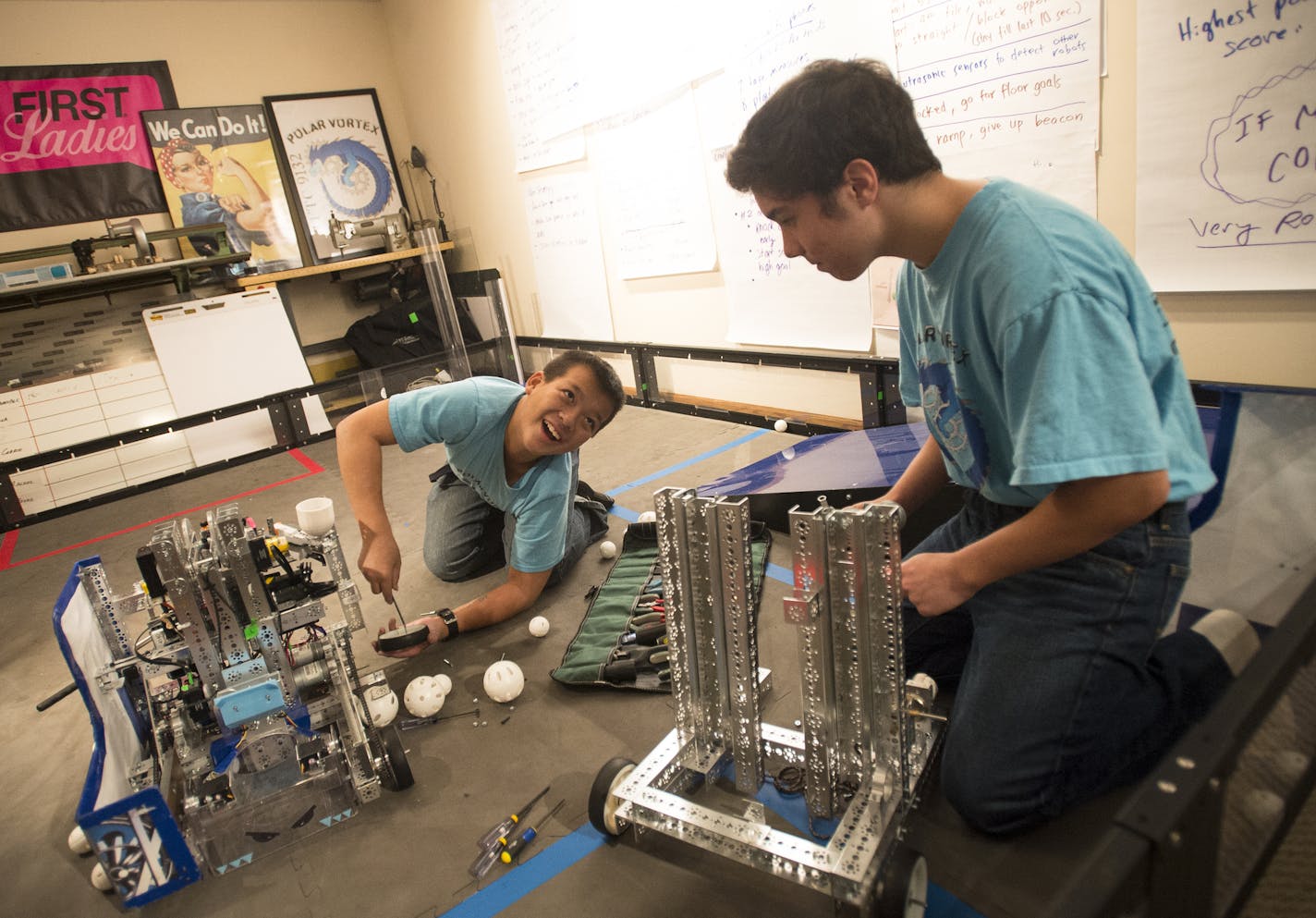 Eighth grader Cody Huynh, left, laughed as he replaced the chain on "FrostByte," the robot of team "Polar Vortex," as Andrew Nguyen worked on disassembling another robot during a team practice Tuesday night. ] Aaron Lavinsky &#x2022; aaron.lavinsky@startribune.com Despite being comprised of mostly freshman girls and not tied to any school, a rookie robotics team from a Lakeville neighborhood has received international recognition along with an invitation to compete in Australia next year. The te