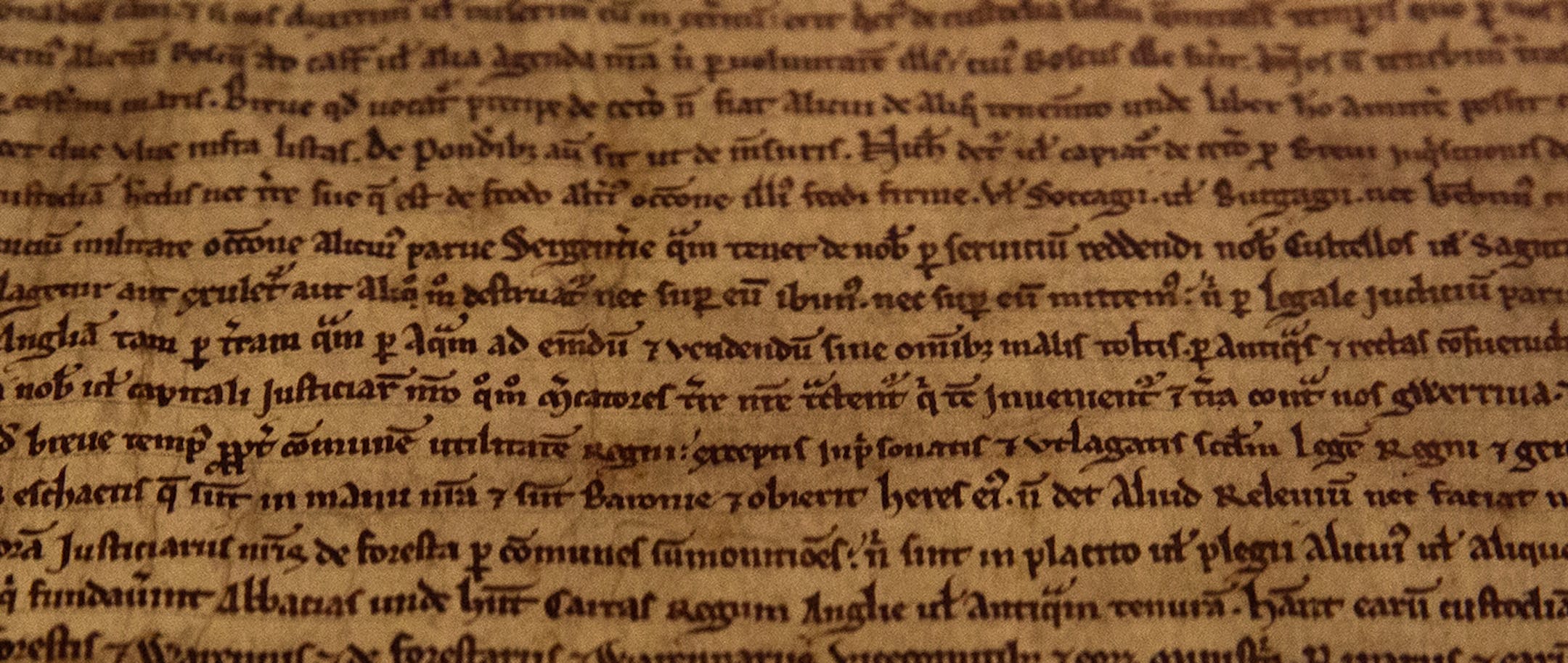 A detail of the Salisbury Magna Carta one of the four original surviving Magna Carta manuscripts that have been brought together by the British Library for the first time, on display at the library during a media preview in London, Monday, Feb. 2, 2015. The event marks the 800th anniversary of the Magna Carta, which established the timeless principle that no individual, even a monarch, is above the law. (AP Photo/Alastair Grant) ORG XMIT: XAG105