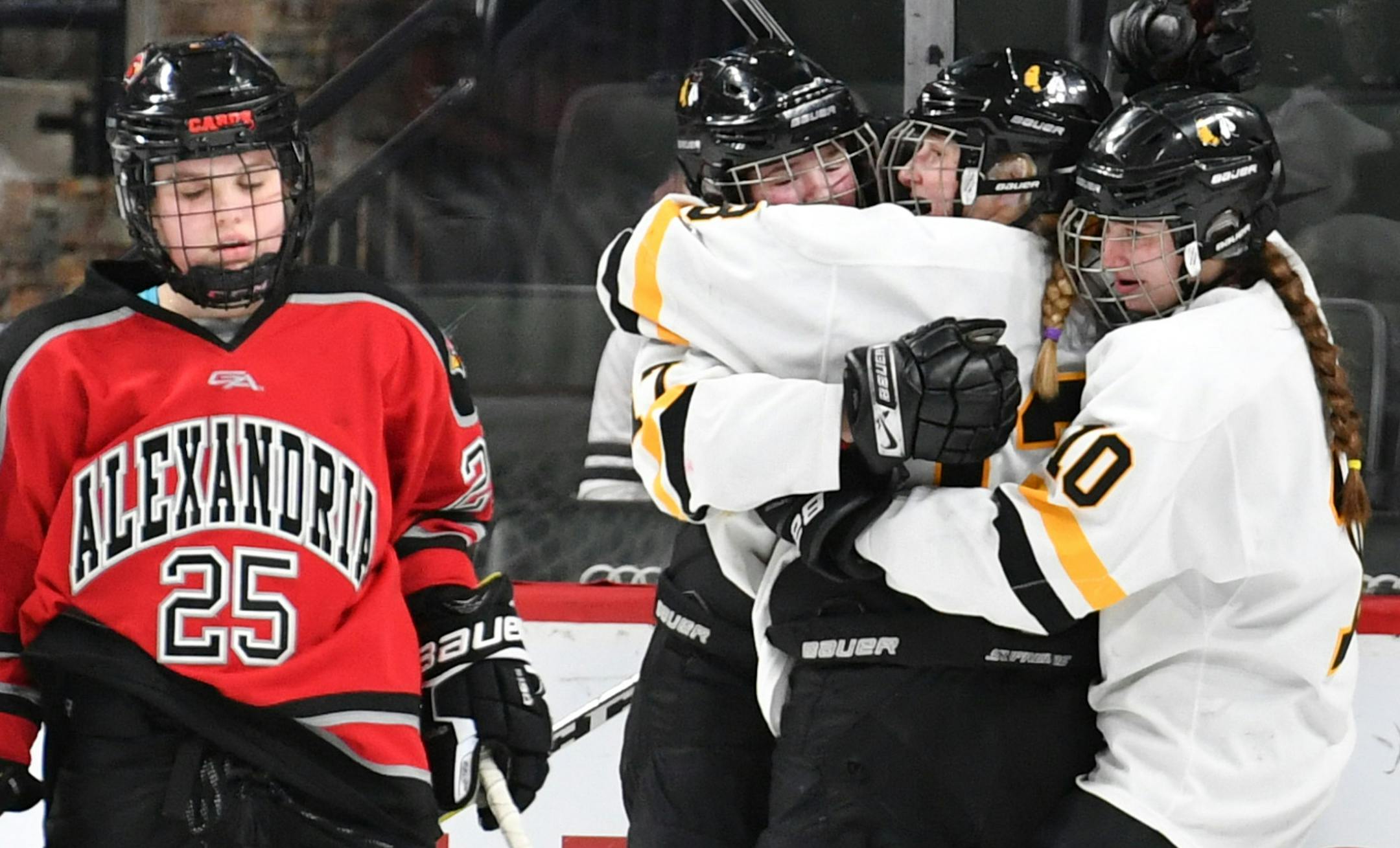 Alexandria player Kaci Trosvig (25) looked dejected as Warroad players celebrated their 5th goal against Alexandria, scored by Geno Hendrickson in the second period. ] GLEN STUBBE • glen.stubbe@startribune.com Friday, February 23, 2018 Class A girls' hockey state tournament quarterfinals. Warroad beat Alexandria 7 to 1