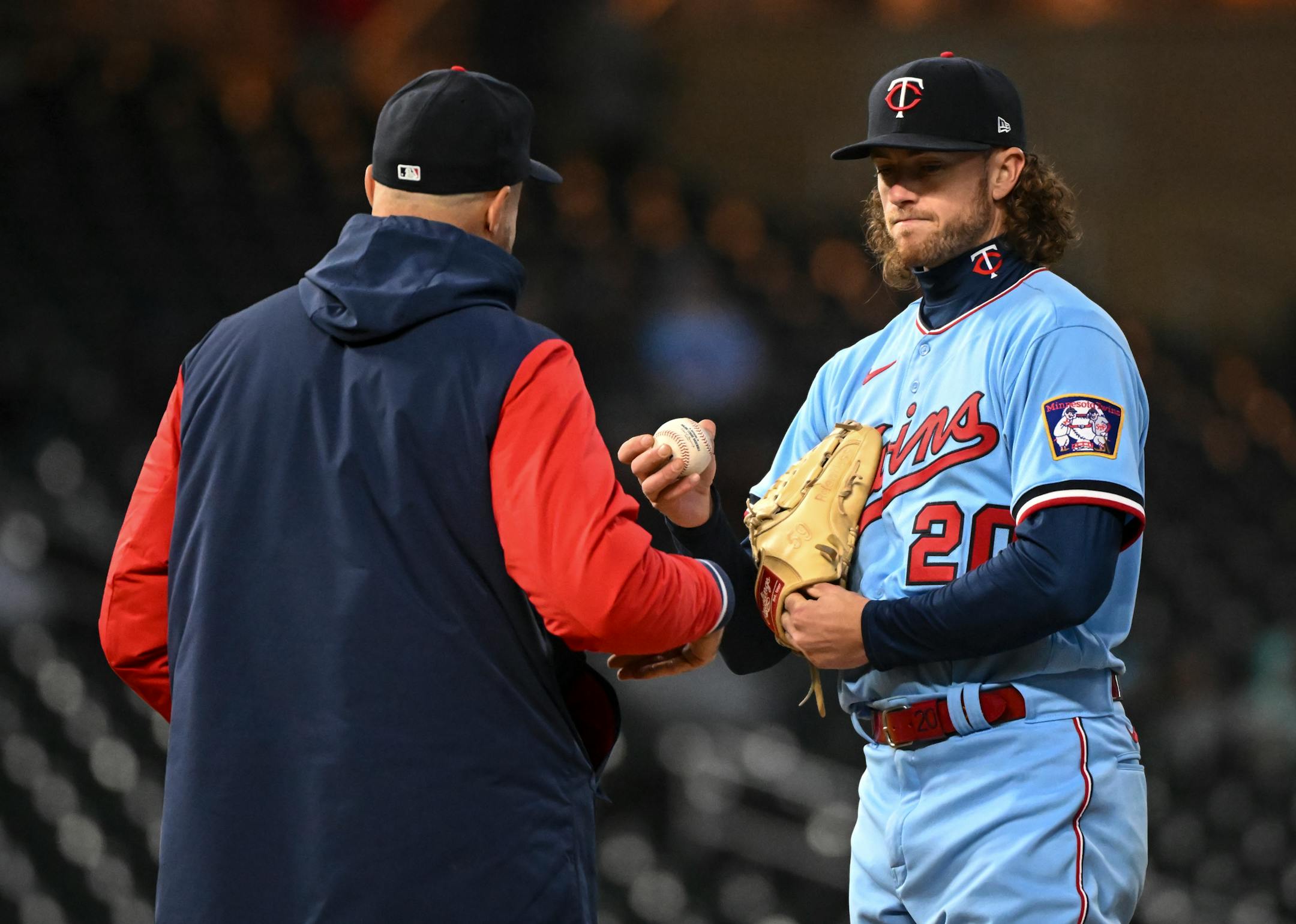 Minnesota Twins starting pitcher Chris Paddack (20) hands the ball to manager Rocco Baldelli (5) as he is relieved in the top of the 6th inning.
