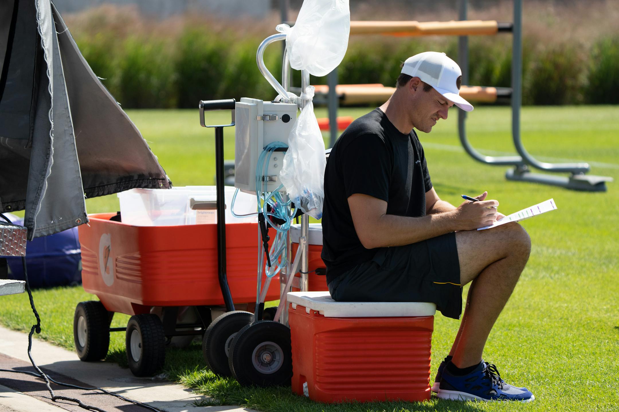 Vikings head coach Kevin O'Connell takes notes.