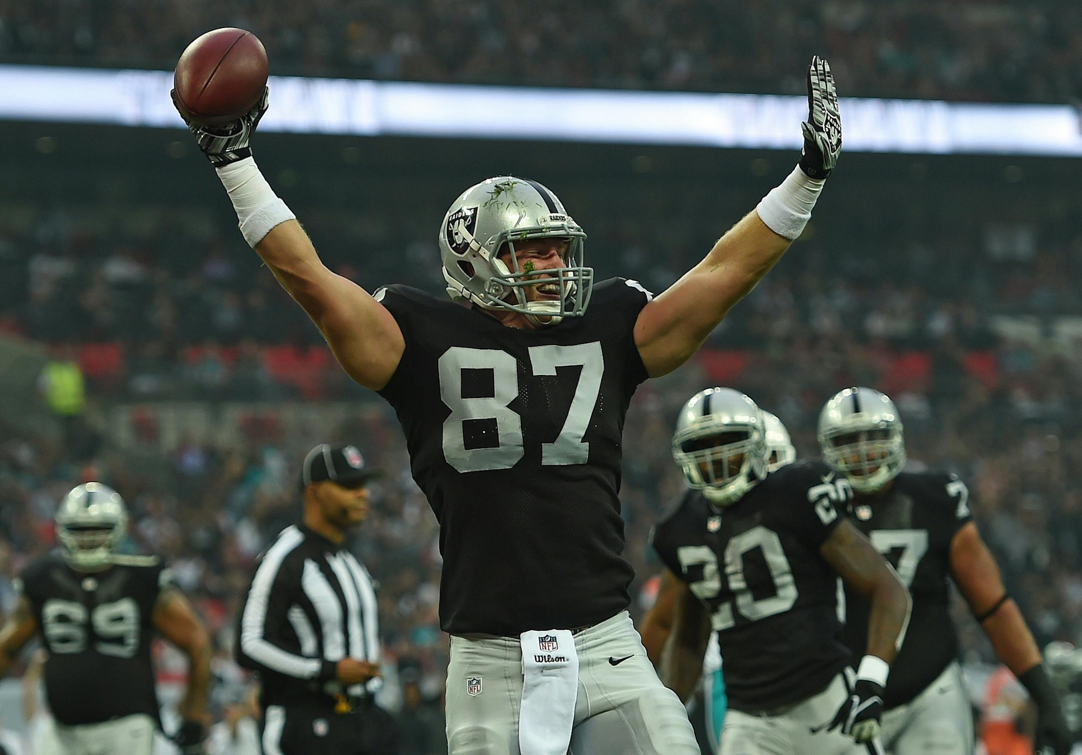 Oakland Raiders' Brian Leonhardt celebrates after scoring a touchdown during the first half of the NFL football game against Miami Dolphins at Wembley Stadium in London, Sunday, Sept. 28, 2014. (AP Photo/Tim Ireland)