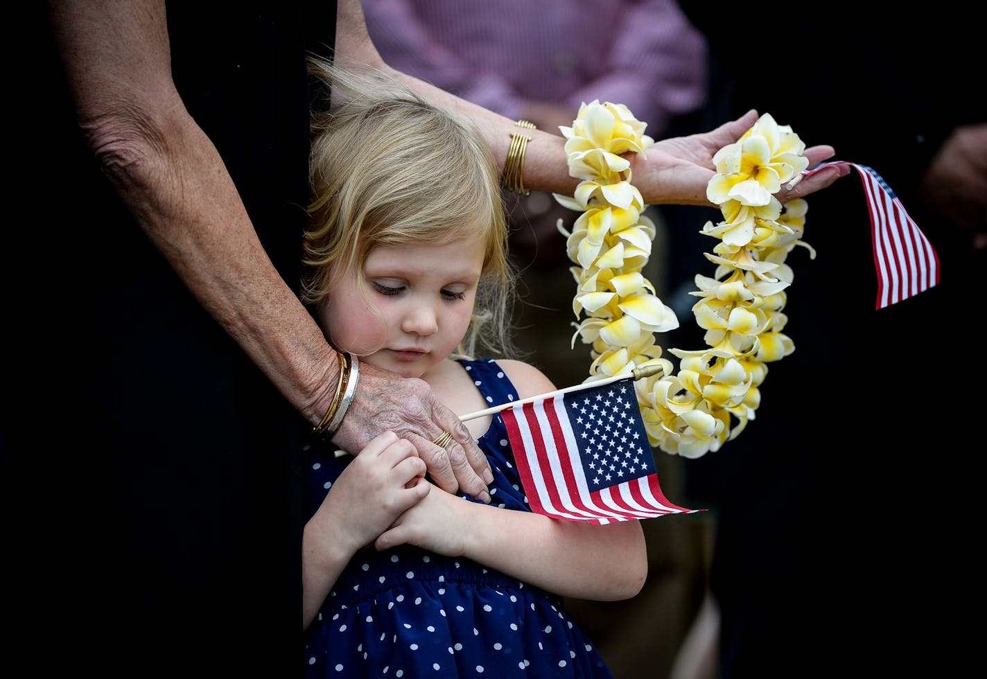 Debra Bidne, niece of Glaydon I.C. Iverson, embraced Lilly Bidne, 5, as Iverson's casket was removed from the hearse Saturday before the burial ceremony. ] AARON LAVINSKY &#xef; aaron.lavinsky@startribune.com Seventy-five years after Glaydon I.C. Iverson was killed aboard the USS Oklahoma at Pearl Harbor, his remains have been identified and returned home, to be buried alongside his family. We photograph the funeral ceremony and burial on Saturday, May 27, 2017 in Emmons, Minn.