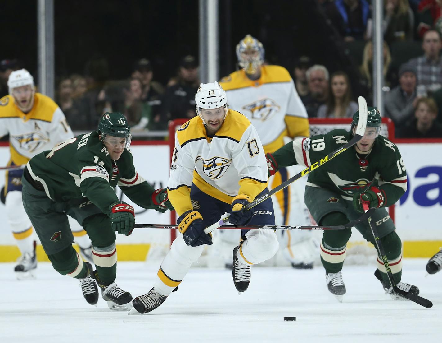 Nick Bonino of the Predators broke past Wild forwards Joel Eriksson Ek (14) and Luke Kunin (19) during a game in 2017.