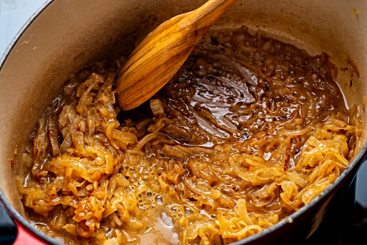 Add the port to deglaze by scraping up any browned bits stuck to the bottom of the pot. MUST CREDIT: Photo by Scott Suchman for The Washington Post.