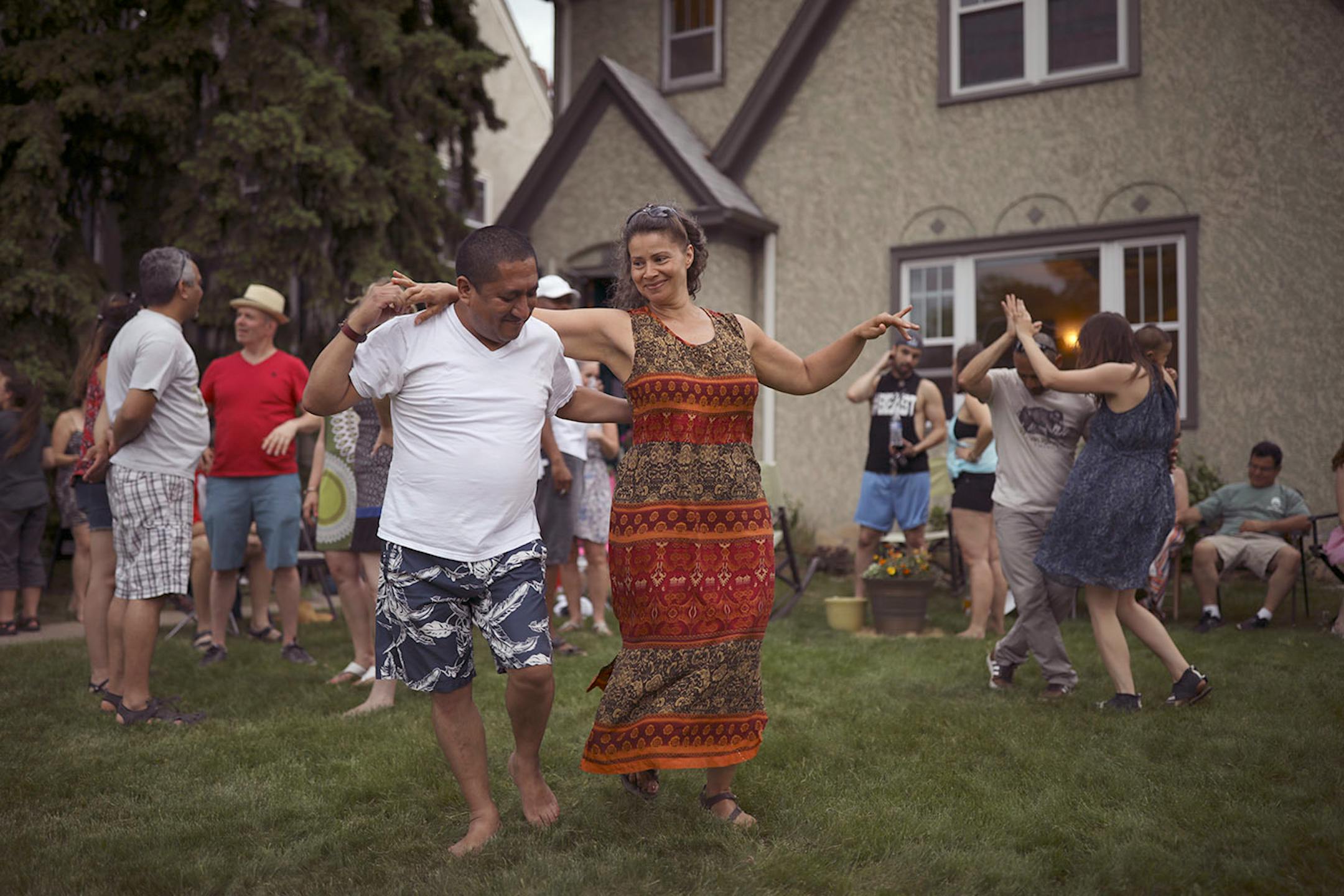 A crowd of friends, including Eddy Maldonado and Monica Matos danced Afro Cuban style on Stephanie Owen's front yard on 28th Ave. S. Monday afternoon. Earlier in the day they had been across the street at Lake Hiawatha Park, but when rain threatened they moved the party to the front yard. "The first of many Memorial Day parties," Owen said.