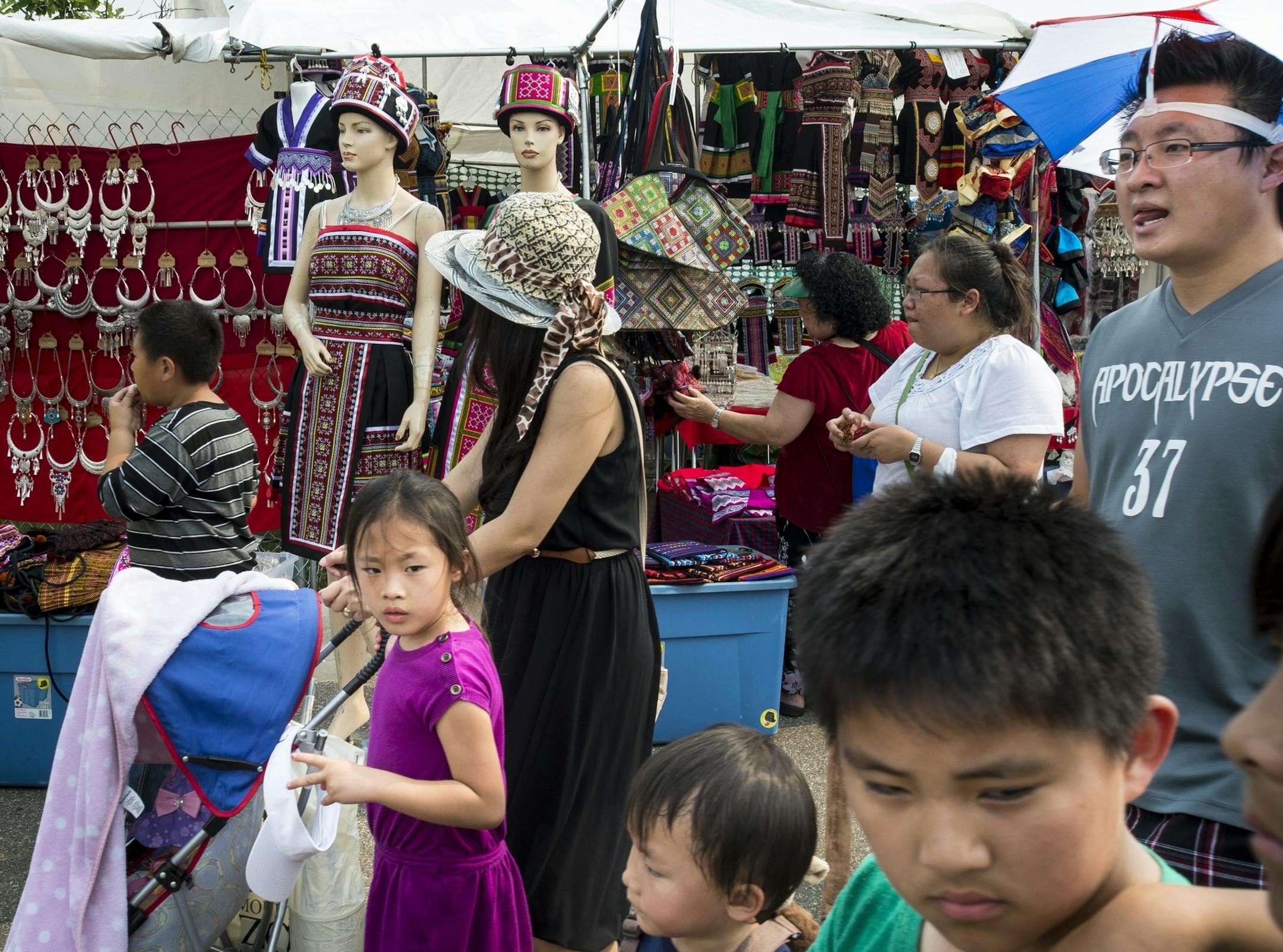 Throngs of people made their way through busy shopping strips at the Hmong Freedom Celebration and Sports Festival on Saturday.
