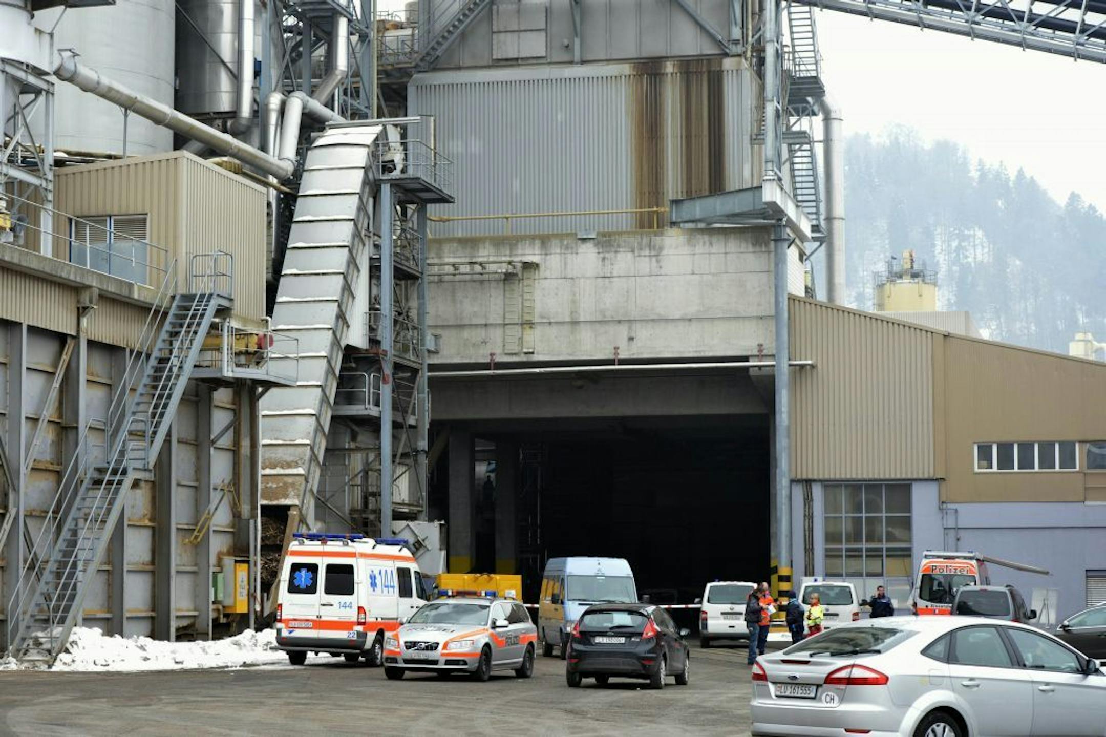 Police stand in front of a wood-processing company in Menznau, central Switzerland, Wednesday, Feb. 27, 2013, where several people were killed in a shooting. Police in Lucerne canton (state) said in a statement that the shooting occurred shortly after 9 a.m. at the premises of Kronospan, a company in the small town west of Lucerne. They said there were �several dead and several seriously injured people� and that rescue services were deployed and the scene sealed off.