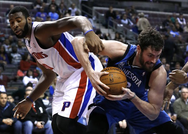 Minnesota Timberwolves power forward Kevin Love, right, grabs a rebound from Detroit Pistons center Andre Drummond (0) in the second half of an NBA ba