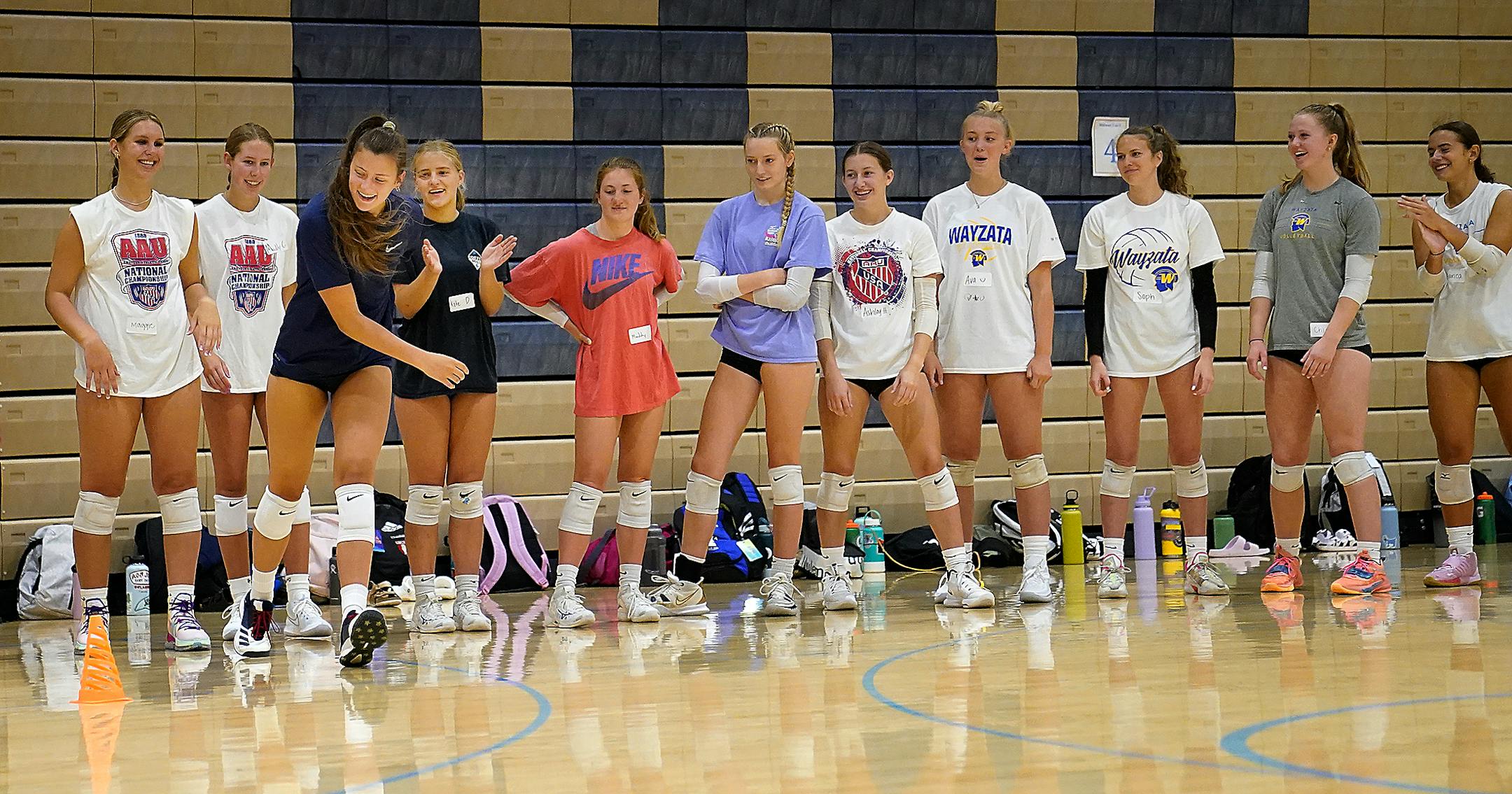 Wayzata High girls volleyball players Stella Swenson, third from left, run backwards during a drill with teammates.