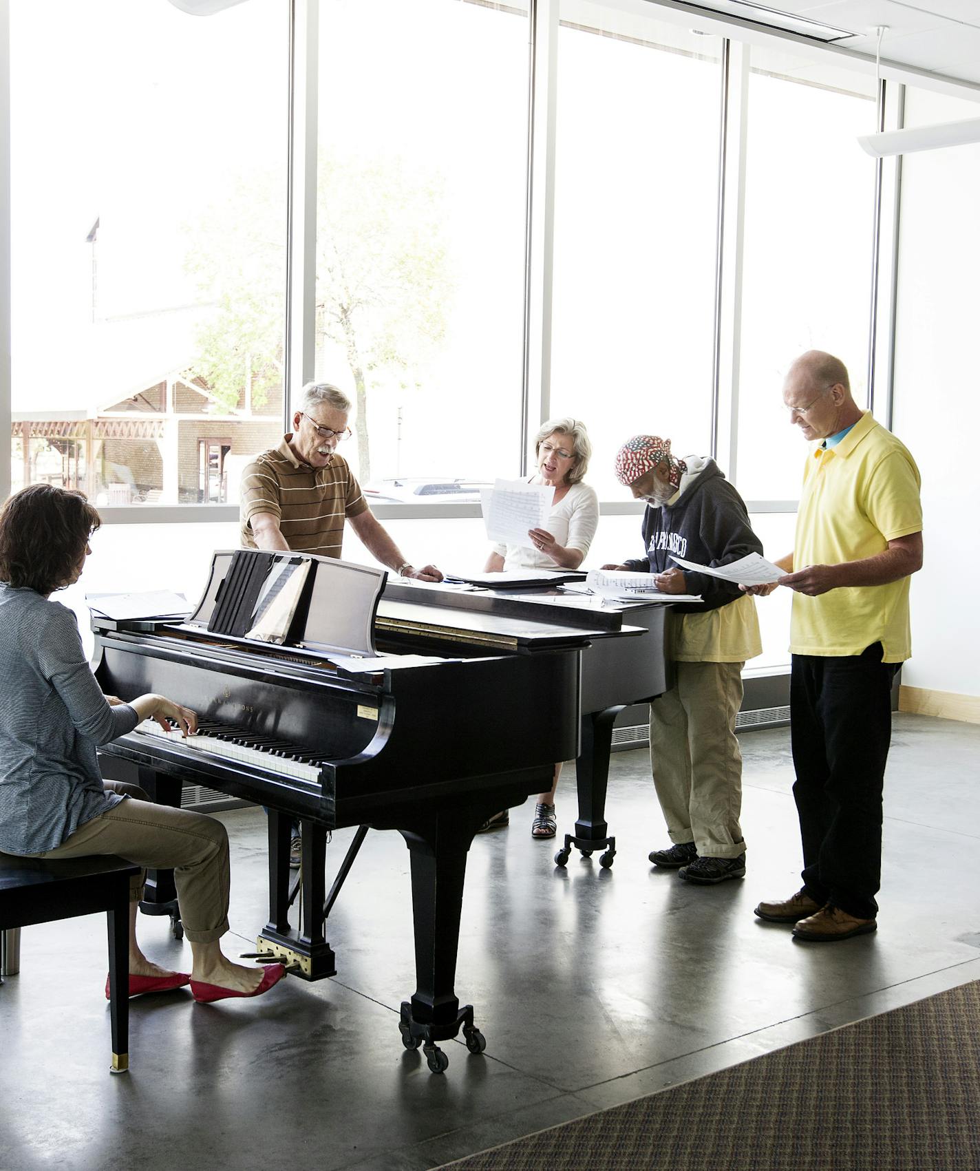 Standing left to right, Charles Reinhart, Cindy Dittmer, Krishna Seshan, and Gary Anderson work on a song in Andrea Leap's Singing Basics class at MacPhail Center for Music in Minneapolis July 15, 2014. (Courtney Perry/Special to the Star Tribune)