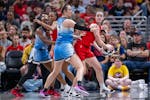 Indiana Fever guard Caitlin Clark, right, looks to pass as Chicago Sky guard Marina Mabrey (4) defends during the second half of a WNBA basketball gam