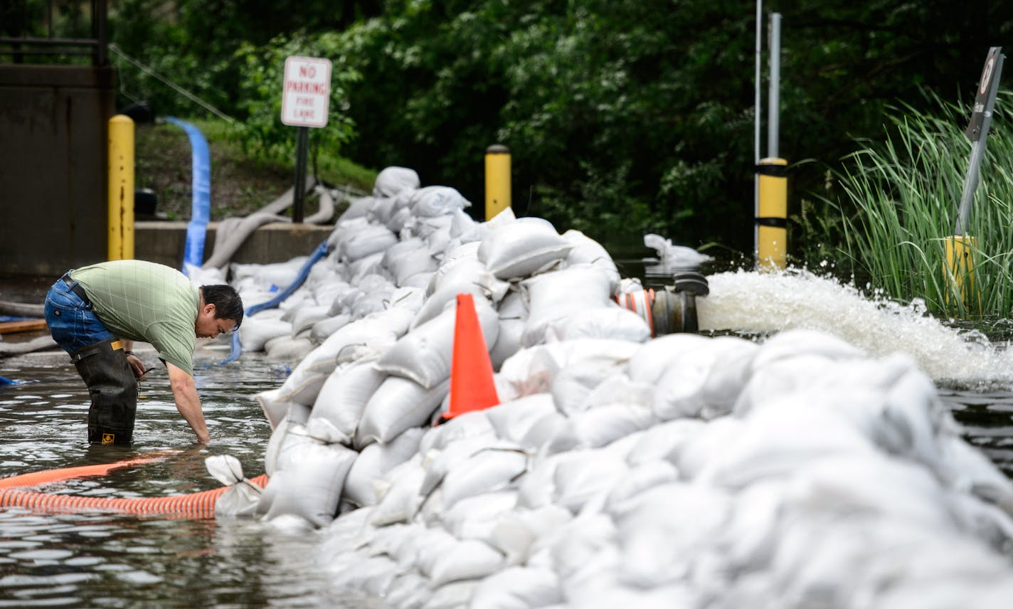 Heavy rains pushed Minnehaha Creek over its banks and workers at Park Nicollet Methodist Hospital brought in extra pumps and sandbags to keep it away from the St. Louis Park hospital. ] GLEN STUBBE * gstubbe@startribune.com Wednesday June 18, 2014