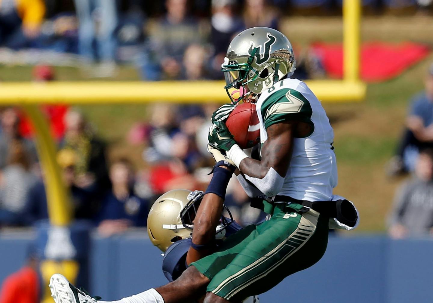 South Florida wide receiver Rodney Adams, top, catches a pass over Navy safety Daiquan Thomasson in the first half of an NCAA college football game, Saturday, Oct. 31, 2015, in Annapolis, Md. (AP Photo/Patrick Semansky)