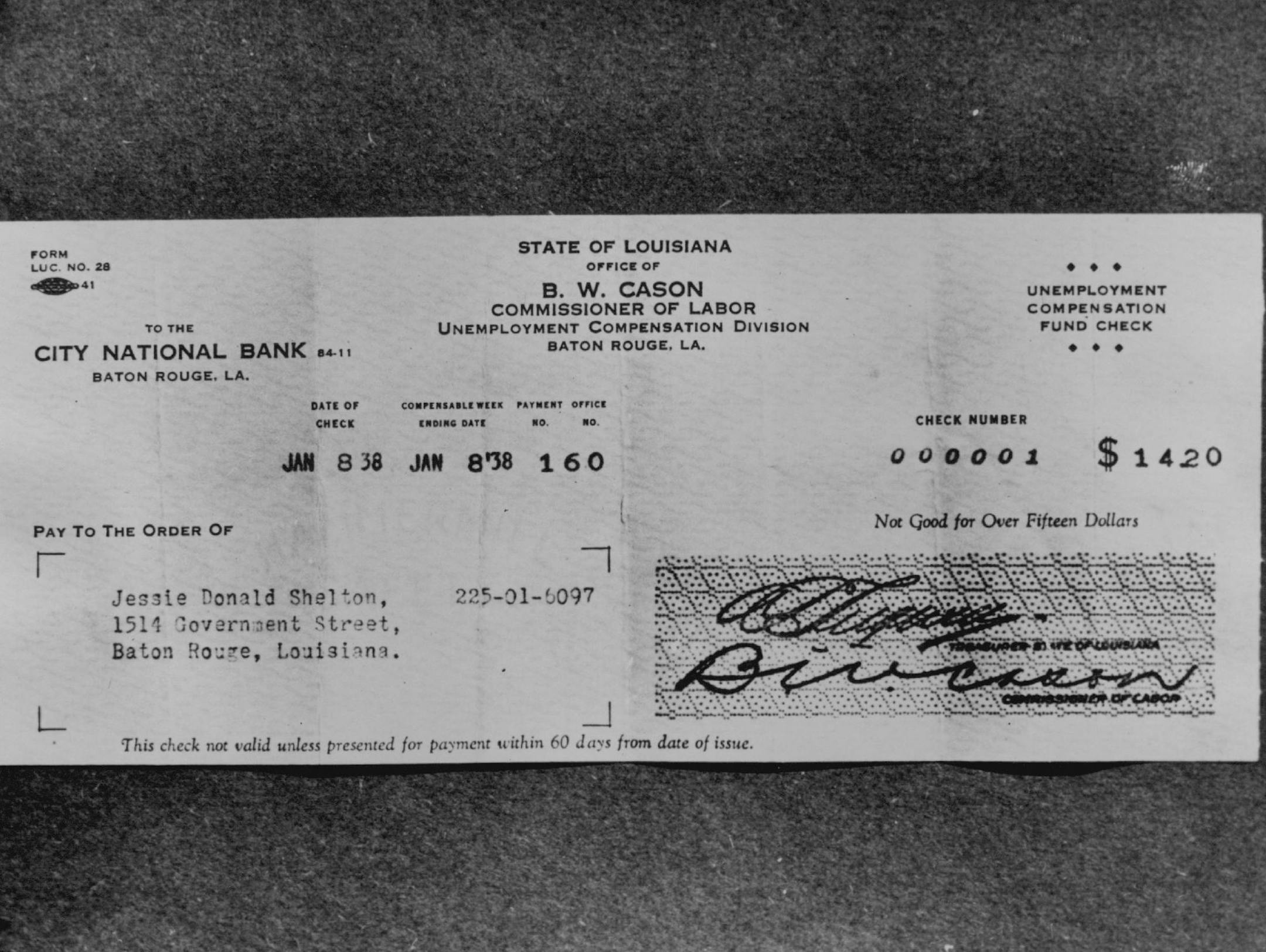 January 9, 1938 The first check paid in the United States under the unemployment compensation program established by the federal social security act, which was received by J.D. Shelton, 37, recently unemployed painter of this place. The check for $14.20 was personally presented to Shelton by B. W. Cason, commissioner of the Louisiana Department of Labor, January 8. Note the check number. Wide World Photo; Minneapolis Star Library