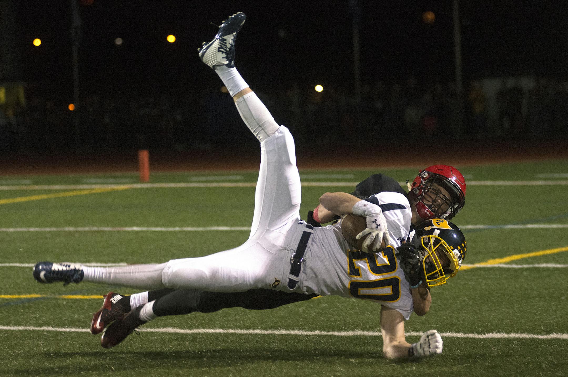 Prior Lake's Jacob Hitz comes down with a long pass during the second quarter and Eden Prairie defender Kal Lunde on his back during the second quarter of Friday night's game at Eden Prairie High School. ] (Matthew Hintz, 092515, Eden Prairie)