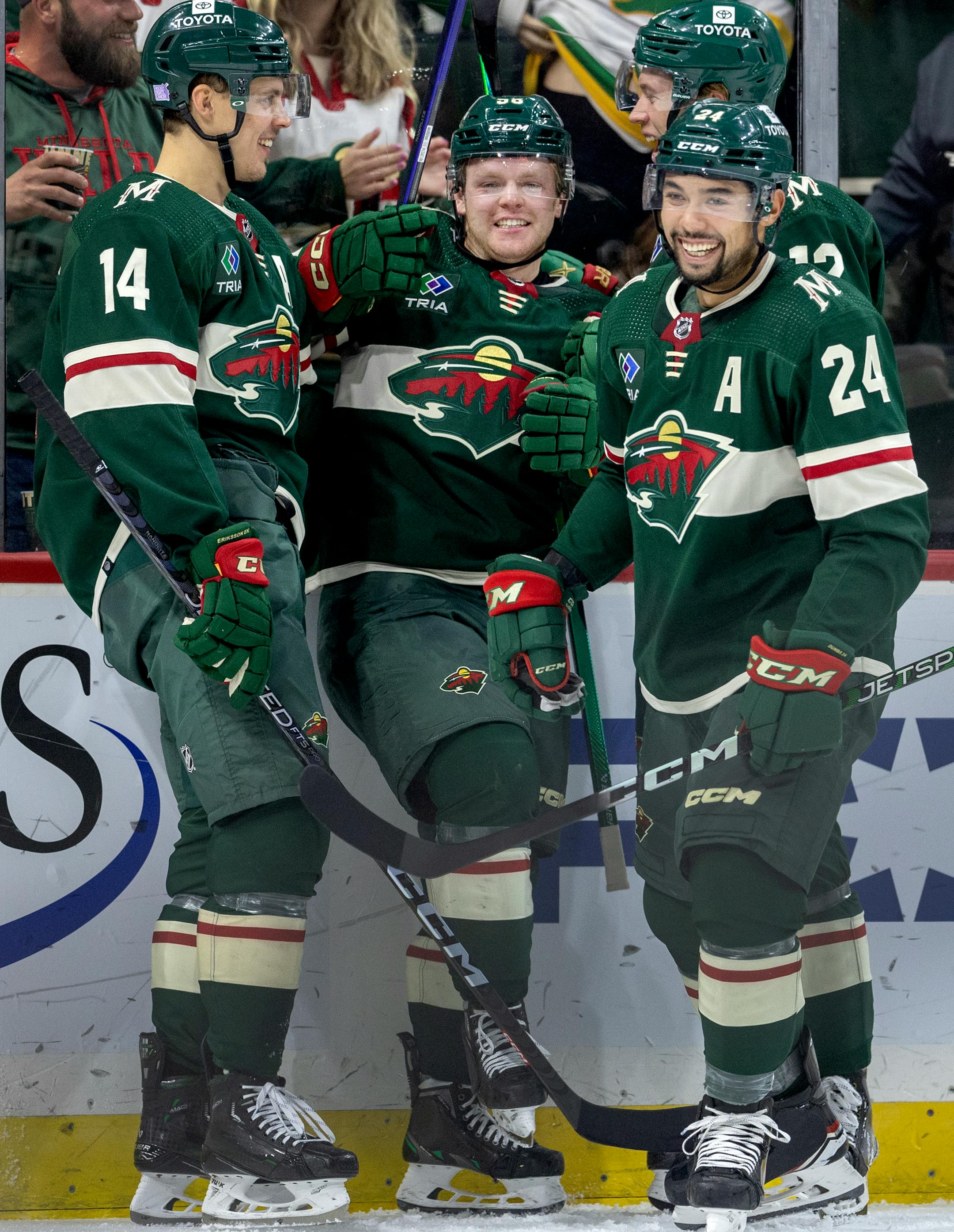 Mason Shaw (58) of the Minnesota Wild celebrates with teammates after scoring a goal in the second period.