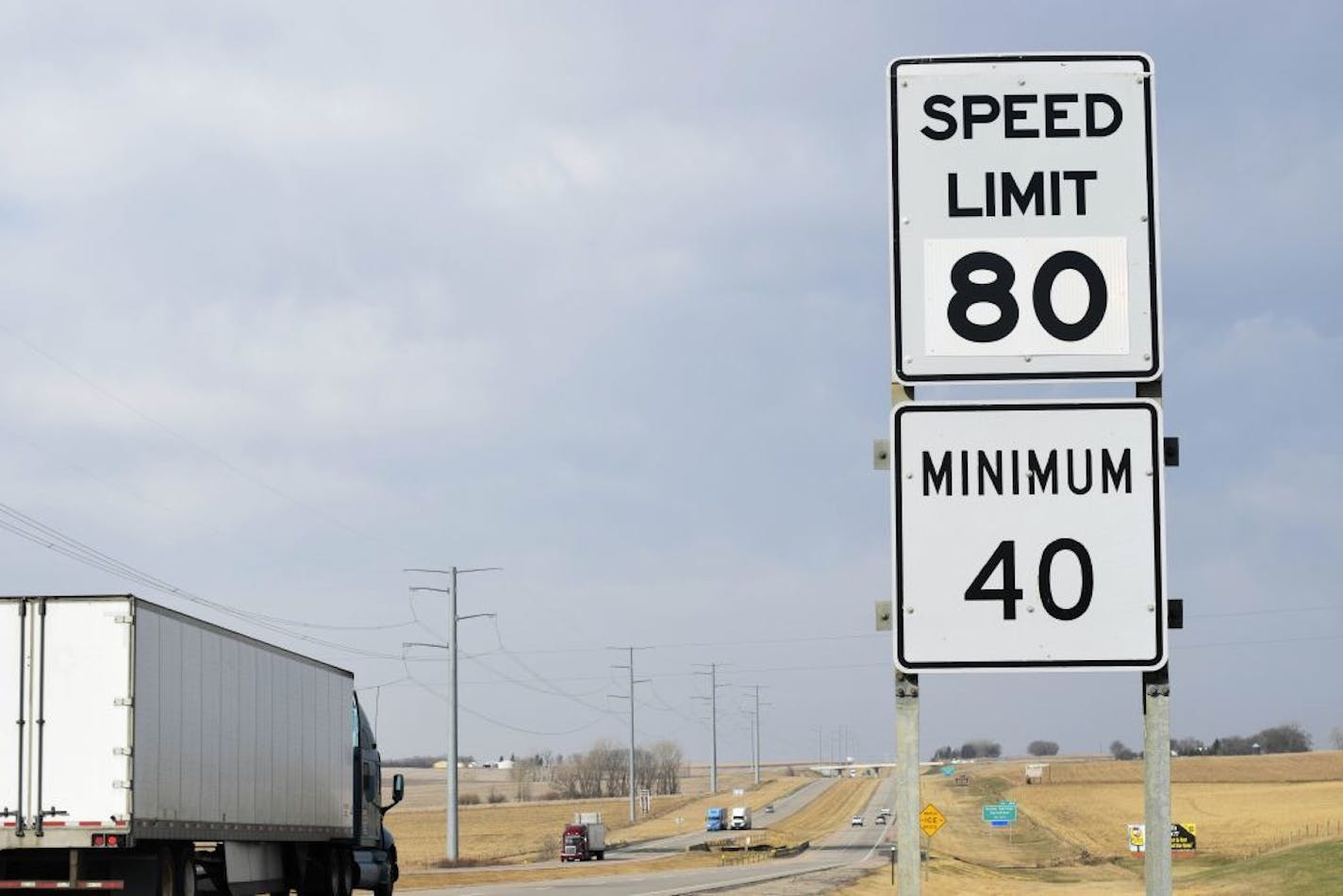 A semi-truck passes by a newly posted 80 mph speed limit sign on Interstate 90 near Brandon, S.D., Wednesday, April 1, 2015, Department of Transportation workers posted the new signs on I-90 and I-29 throughout the state to reflect a new state law that took effect Wednesday allowing for the higher speeds.