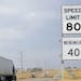 A semi-truck passes by a newly posted 80 mph speed limit sign on Interstate 90 near Brandon, S.D., Wednesday, April 1, 2015, Department of Transportat