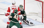 The Wild's Devan Dubnyk and Jared Spurgeon (46) and the Red Wings' Dylan Larkin (71) watched as the shot of the Red Wings' Gustav Nyquist trickled int