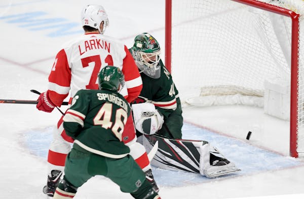 The Wild's Devan Dubnyk and Jared Spurgeon (46) and the Red Wings' Dylan Larkin (71) watched as the shot of the Red Wings' Gustav Nyquist trickled int