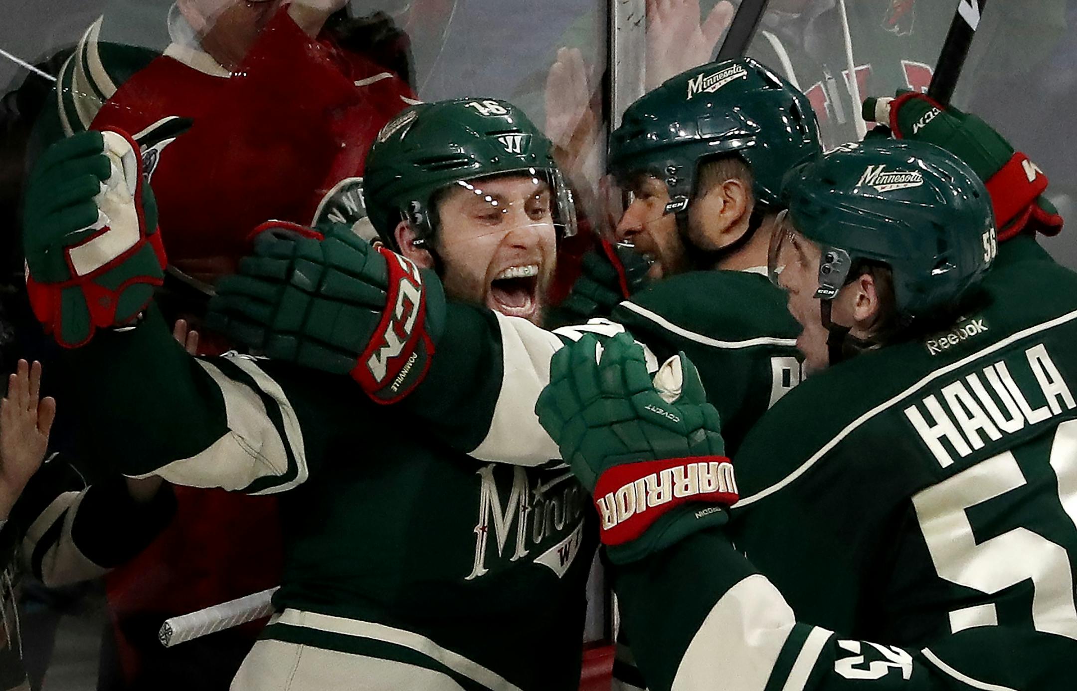 Jason Zucker (16) celebrated with teammates after scoring a goal in the third period. The goal tied up the score to take the game into overtime.