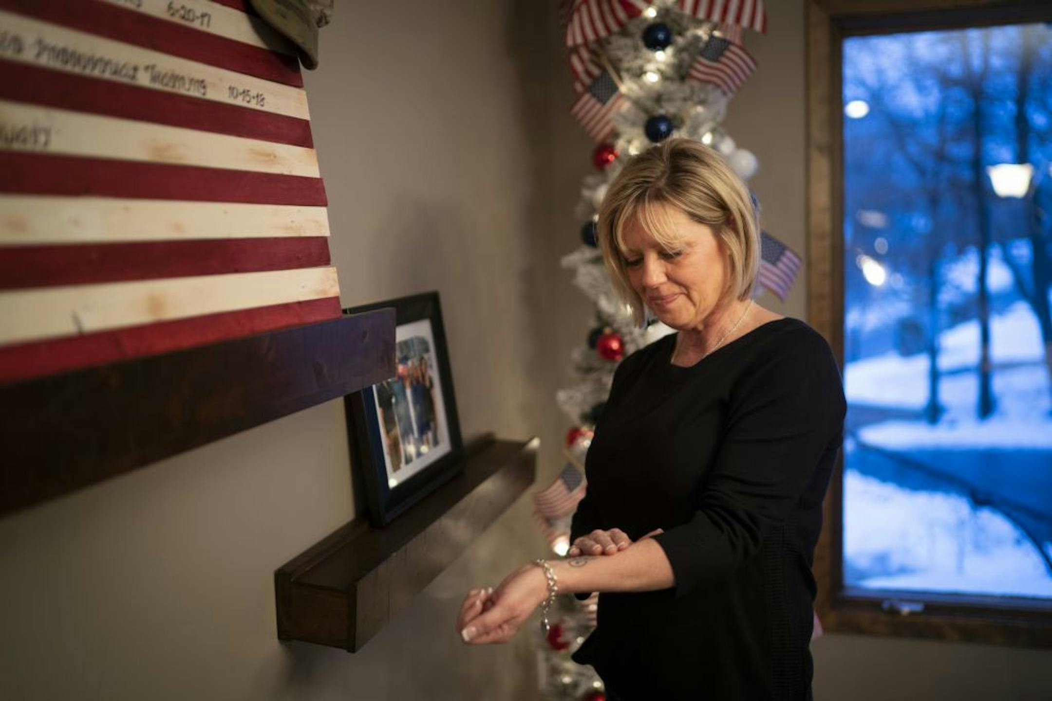 Yvonne Herzan gets emotional every time she rubs a Celtic symbol for "breath" on her wrist, the same tattoo her daughter Sarah Riviere Herzan got before she deployed to the Middle East for the National Guard this fall. Herzan says she has cried at least 5 times in the last 24 hours worrying about her daughter serving in the Middle East after escalating tensions with Iran. She is photographed in Eden Prairie, Minn., on Friday, January 3, 2020.