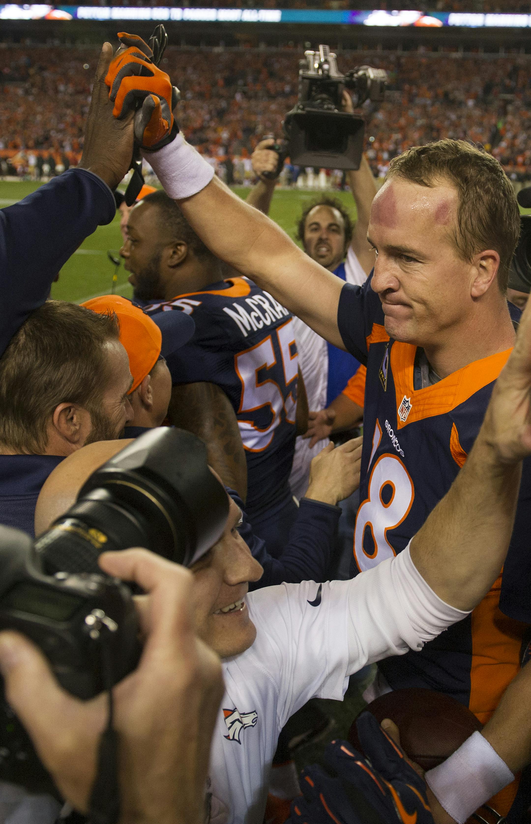 Denver Broncos' Peyton Manning and Demaryius Thomas are congratulated after connecting for Manning's record 509th career touchdown pass during the second quarter on Sunday, Oct. 19, 2014, at Sports Authority Field at Mile High in Denver. (Mark Reis/Colorado Springs Gazette/MCT)