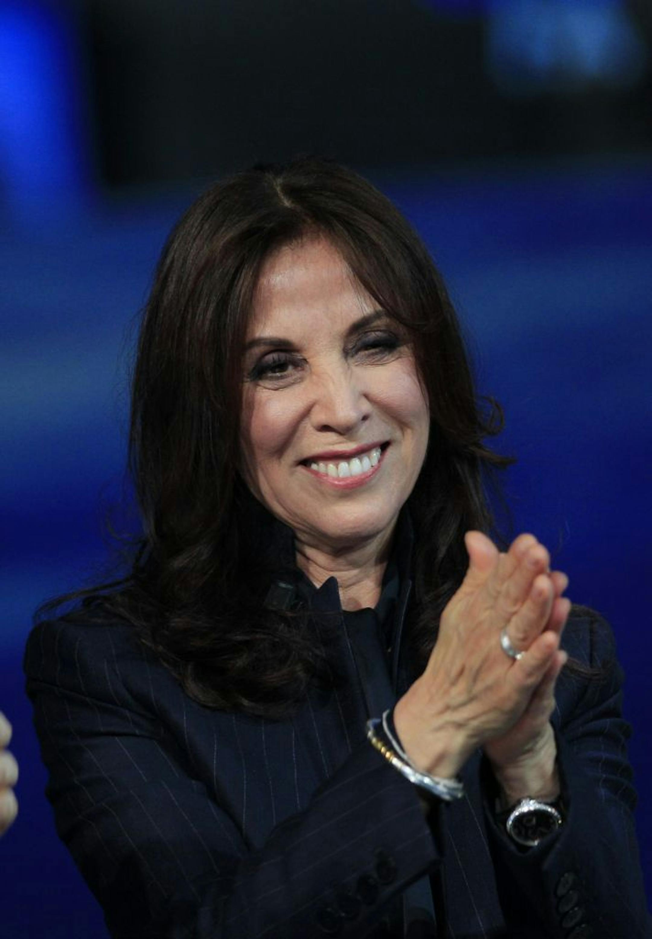 FILE - In this April 14, 2012 file photo, Olivia Harrison, the widow of George Harrison, former member of The Beatles attends the Italian State RAI TV program "Che Tempo che Fa", in Milan, Italy. George Harrison's widow Olivia hopes to add a more personal side to the reticent Beatle with her new multi-touch book. Based on the documentary, �George Harrison: Living in the Material World,� the book is available Tuesday, May 1, on the iTunes bookstore. It includes audio, video material from the film