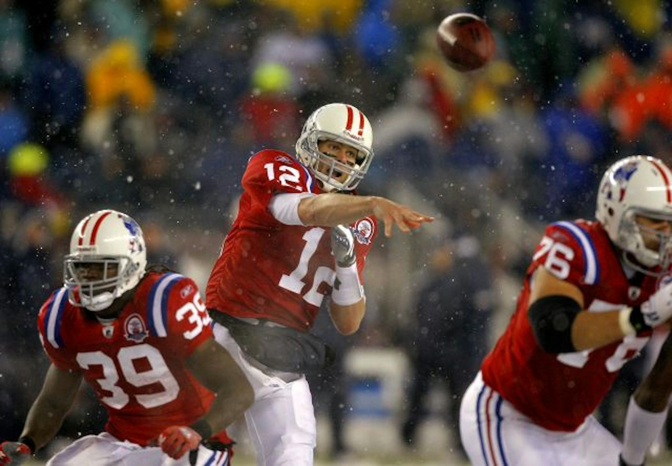 New England Patriots quarterback Tom Brady (12) throws a pass wide receiver Sam Aiken as running back Laurence Maroney (39) and Patriots offensive lineman Sebastian Vollmer (76) block during the third quarter of their NFL football game against the Tennessee Titans in Foxborough, Mass., Sunday afternoon, Oct. 18, 2009. Brady was 29 of 34 for 380 yards and six touchdowns in less than three quarters of play as the Patriots defeated the Titans 59-0.