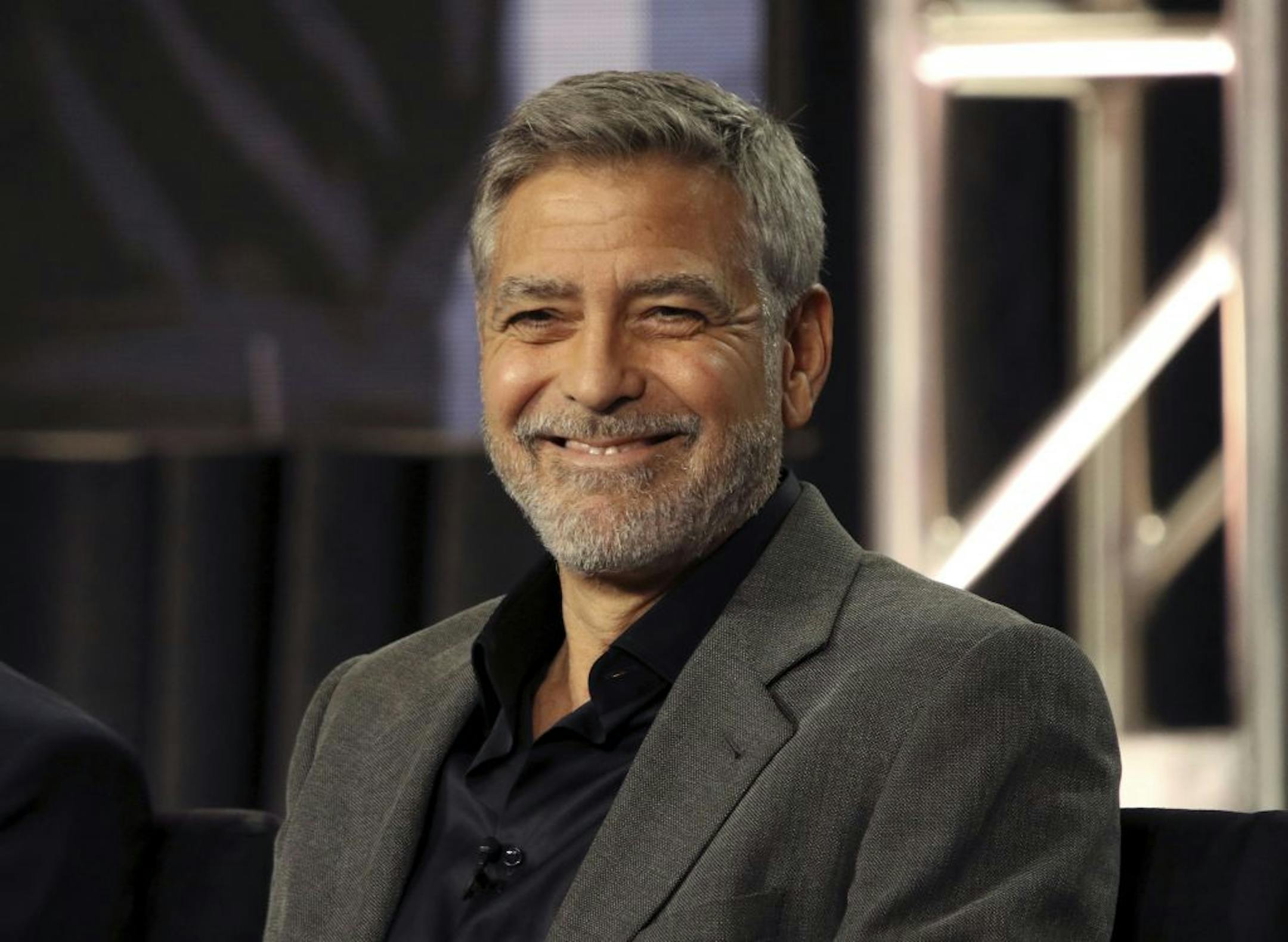 In this Feb. 11, 2019 photo, George Clooney participates in the "Catch-22" panel during the Hulu presentation at the Television Critics Association Winter Press Tour at The Langham Huntington in Pasadena, Calif. In a Sunday, Nov. 29, 2020, interview on "CBS Sunday Morning," Clooney said he's been cutting his own hair for more than two decades with a Flowbee device.