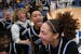 Hopkins players, including guard Liv McGill (23), center, and guard Amaya Battle (5), bottom right, celebrate after a girls' basketball section final.