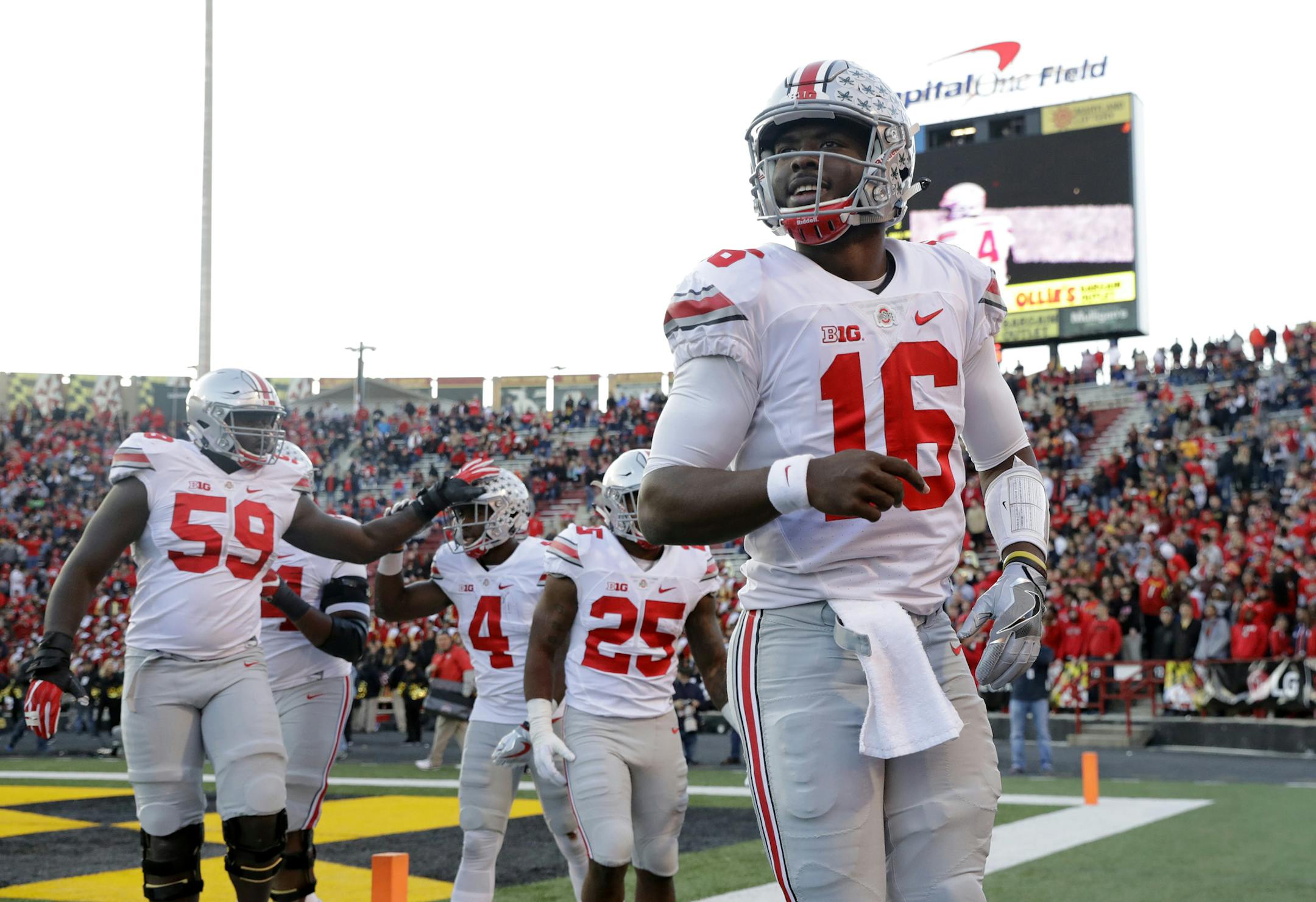 Ohio State quarterback J.T. Barrett (16) celebrates after throwing a touchdown pass to running back Curtis Samuel (4) in the first half of an NCAA college football game against Maryland in College Park, Md., Saturday, Nov. 12, 2016. (AP Photo/Patrick Semansky) ORG XMIT: MIN2017082520062694