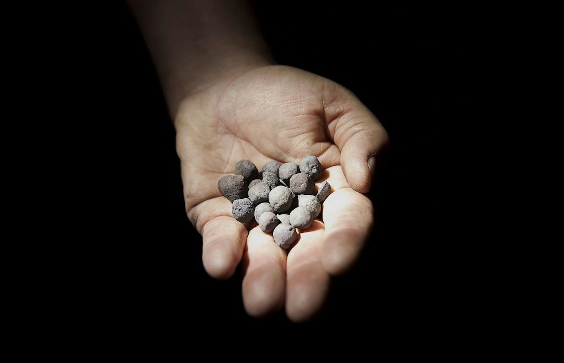 Finished taconite pellets are displayed for a photograph at the Hibbing Taconite Co. pellet manufacturing plant, operated by Cliff's Natural Resources Inc., in Hibbing, Minnesota, U.S., on Thursday, Jan. 5, 2012. Taconite is a sedimentary rock containing low-grade iron ore, which is eventually processed into small pellets that contain approximately 65 percent iron. Photographer: Ariana Lindquist/Bloomberg