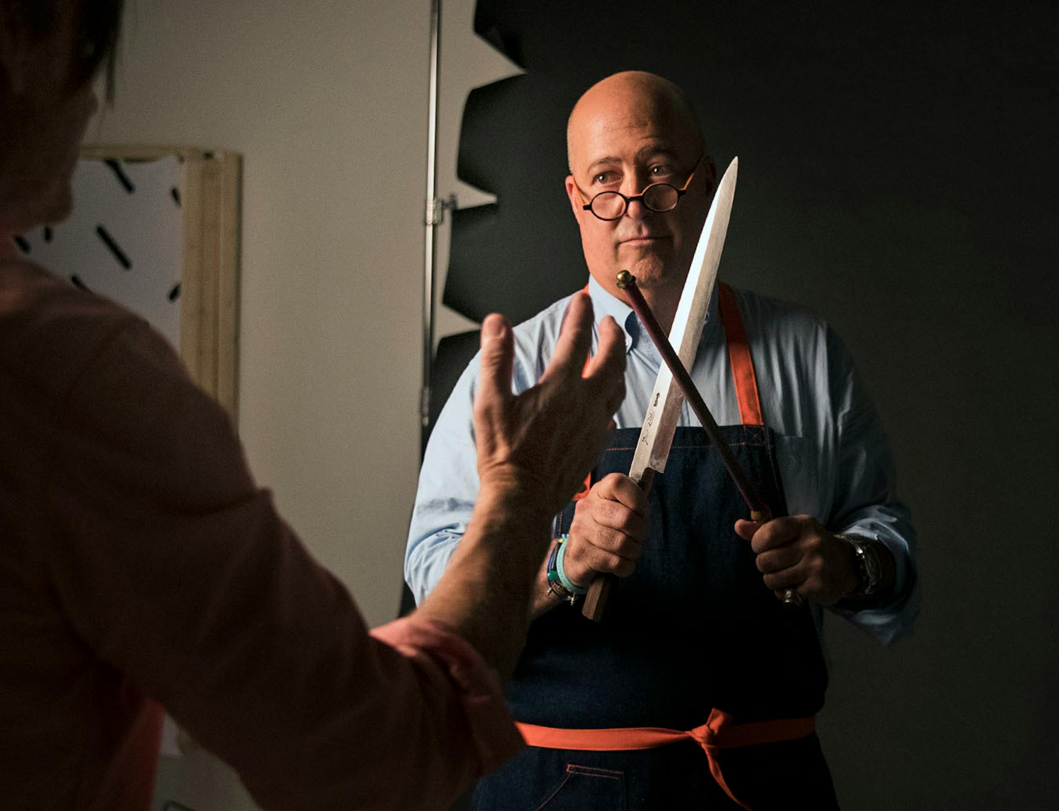Photographer Steve Henke helped arrange a custom made Japanese knife in Andrew Zimmern's hands for a photoshoot for Midwest Living at his studio in Golden Valley, Minn., on Friday, May 26, 2017.