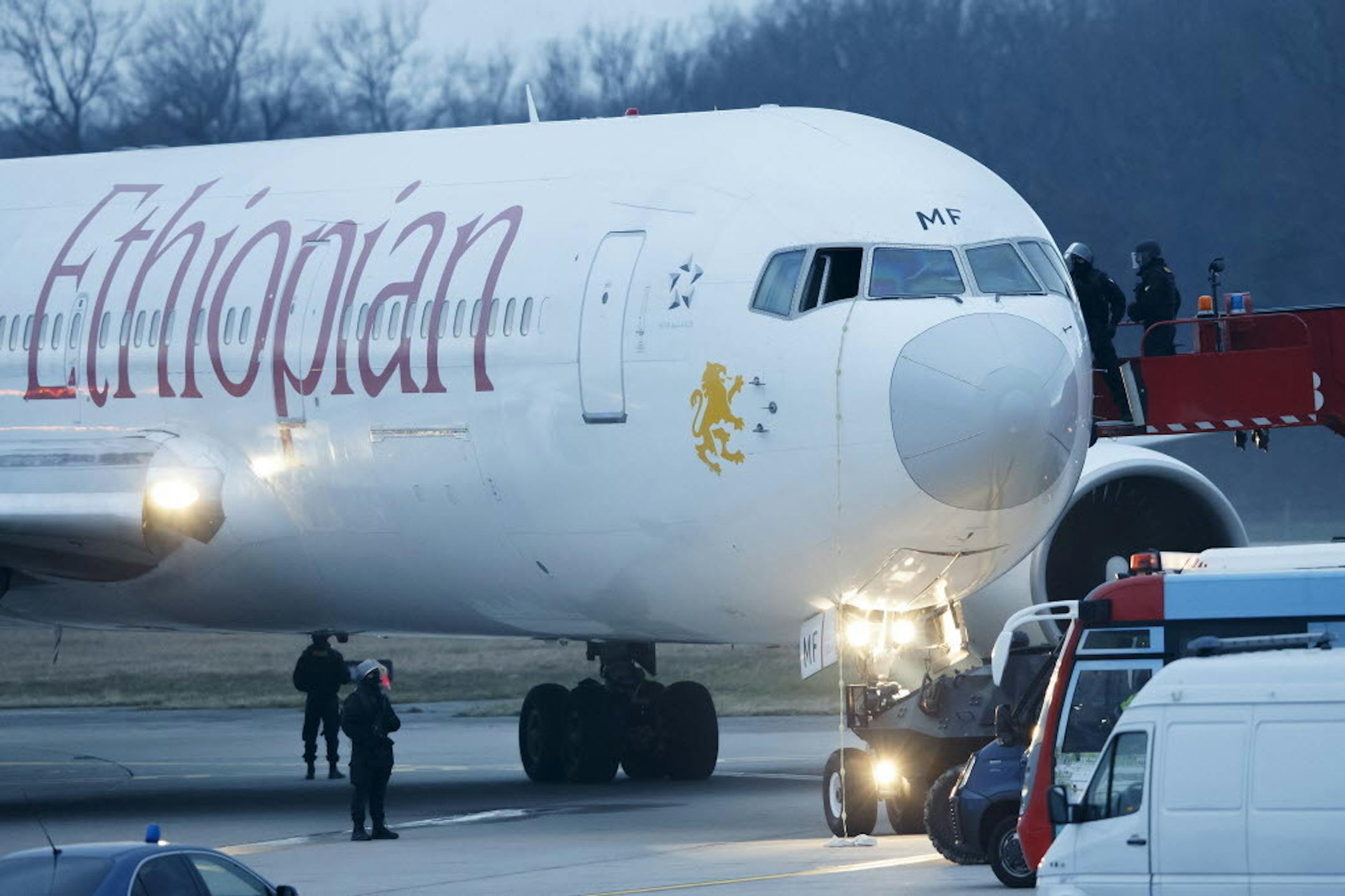 Police stand around the aircraft after passengers were evacuated from a hijacked Ethiopian Airlines Plane on the airport in Geneva, Switzerland, Monday, Feb. 17, 2014.