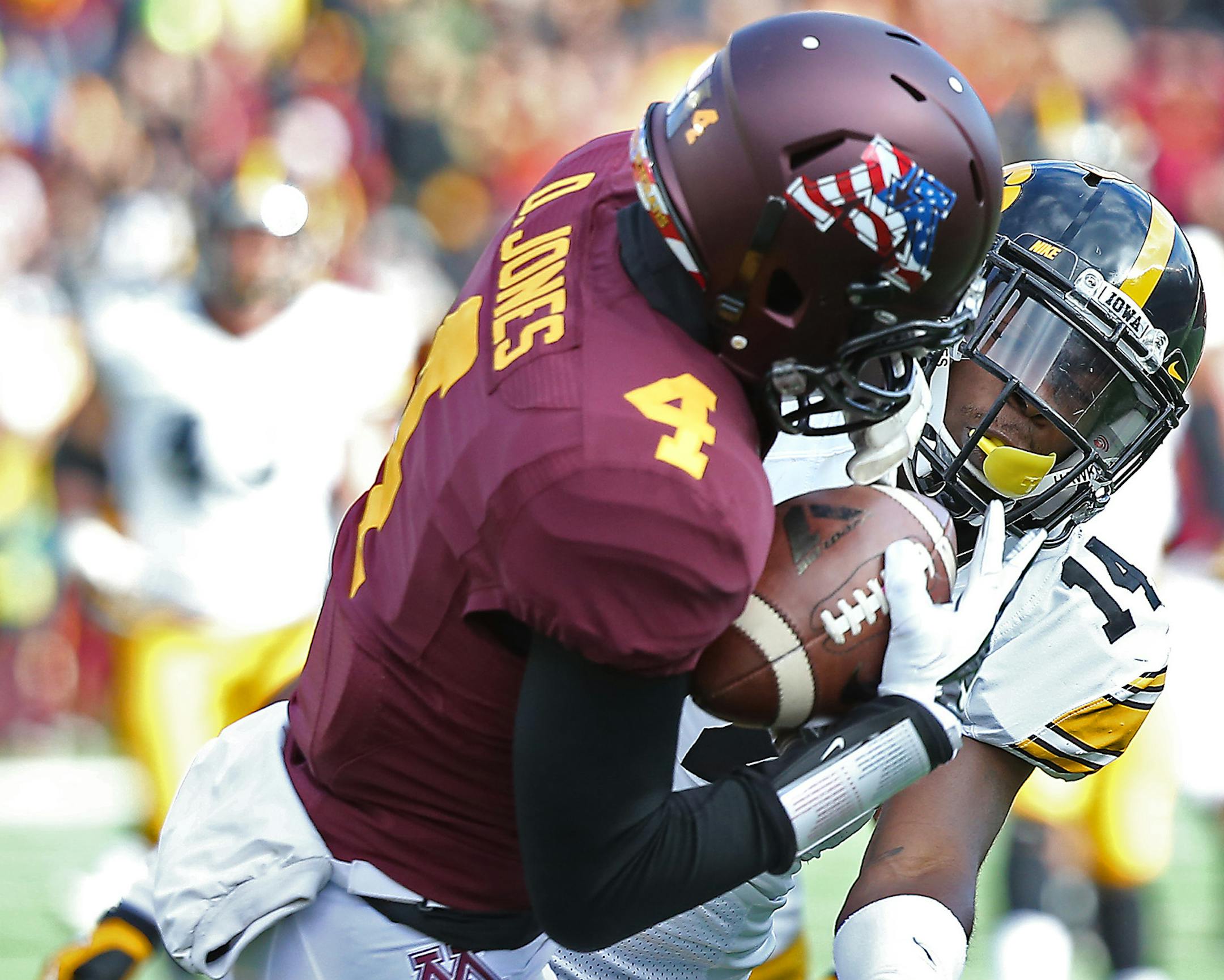 Minnesota's wide receiver Donovahn Jones (4) caught a pass for a touchdown despite pressure from Iowa's defensive back Desmond King on Saturday, November 8, 2014 at TCF Stadium.