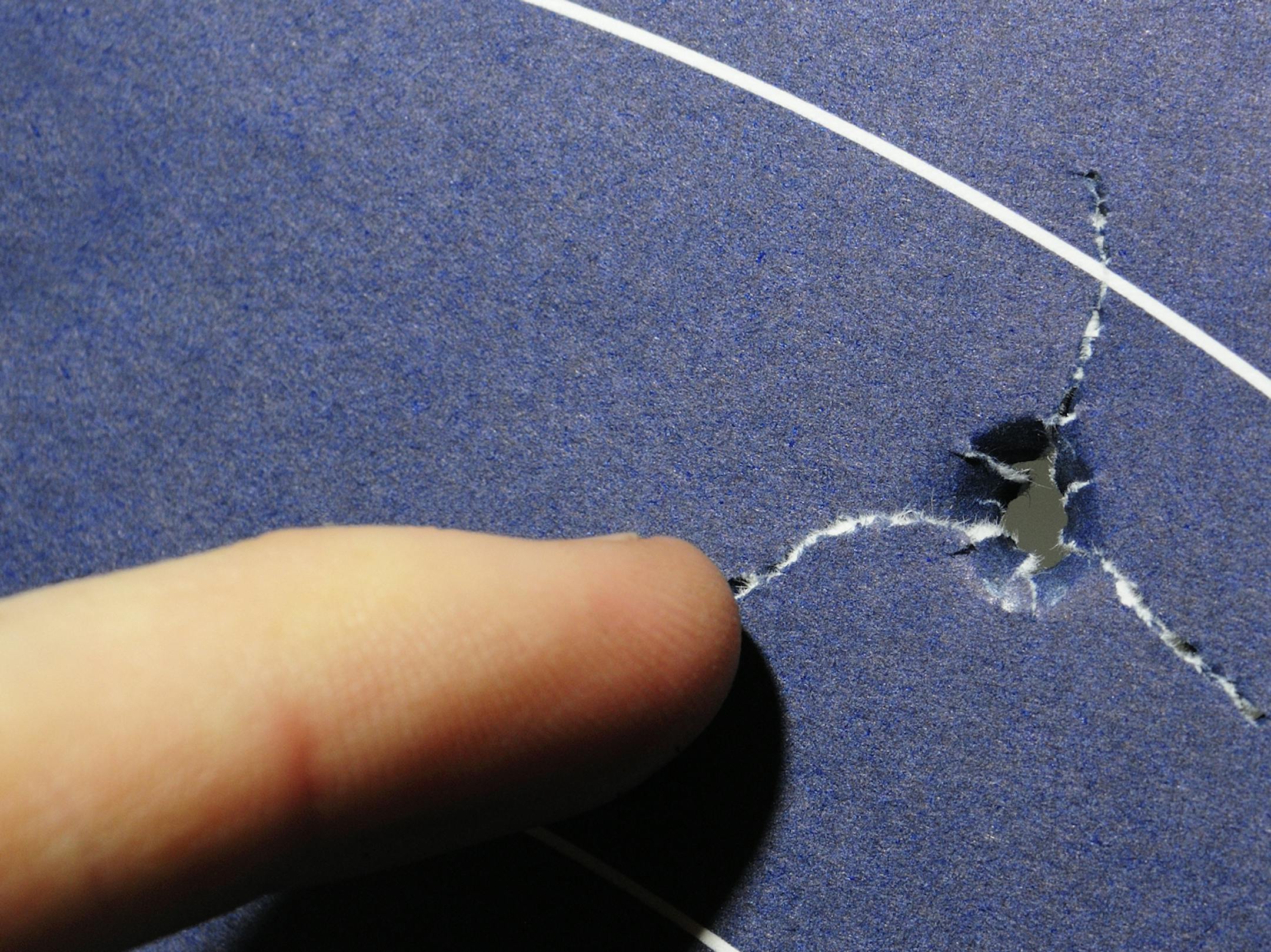 Archers can test arrow flight by shooting a paper target. A properly tuned bow will leave a round hole and tears from the arrow's fletching, as pictured above.