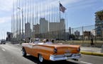 An old car passes in front of the U.S Embassy in Havana, Cuba, on March 17, 2016. (Olivier Douliery/Abaca Press/TNS)
